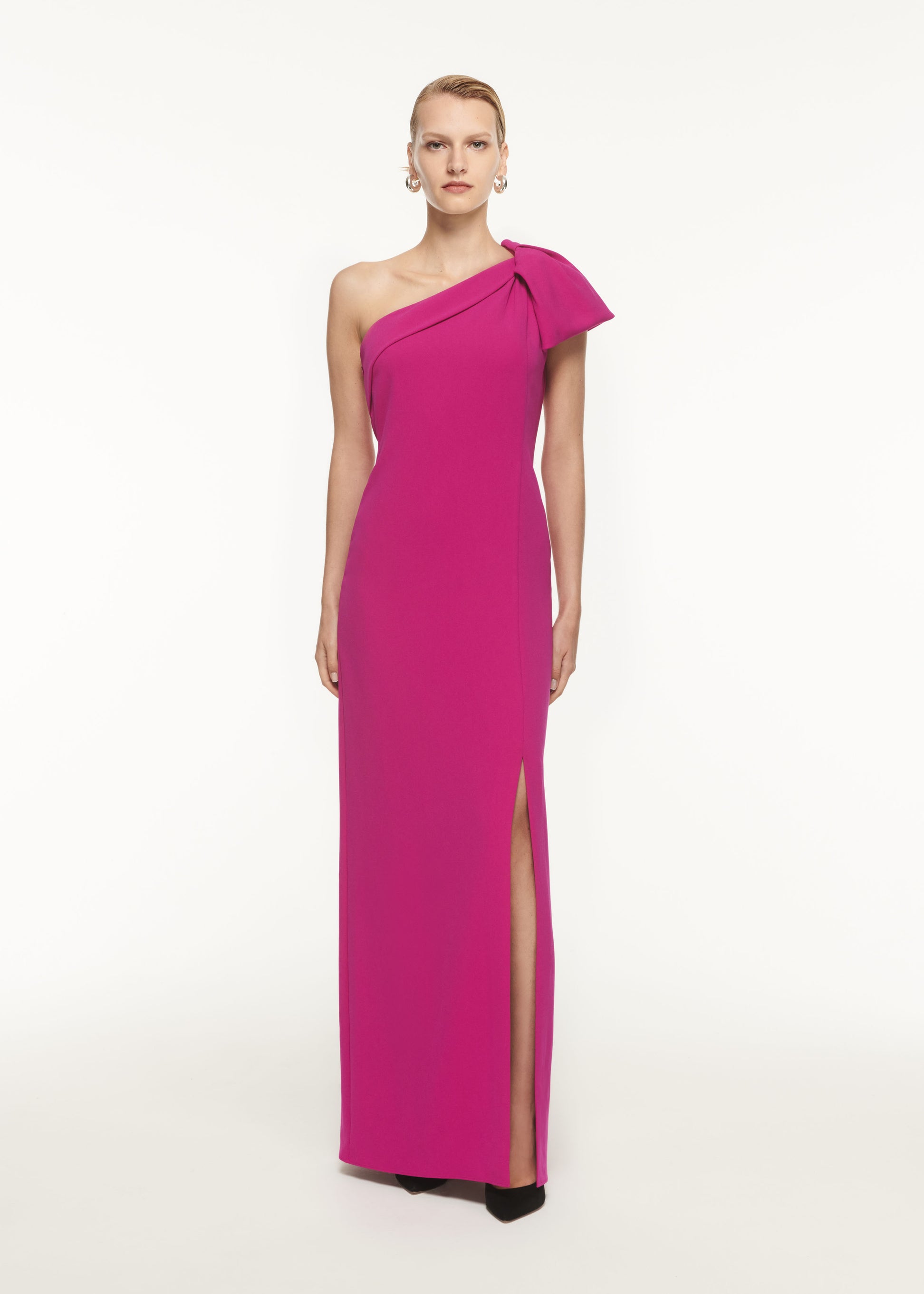 A woman wearing the Asymmetric Stretch Cady Maxi Dress in Purple