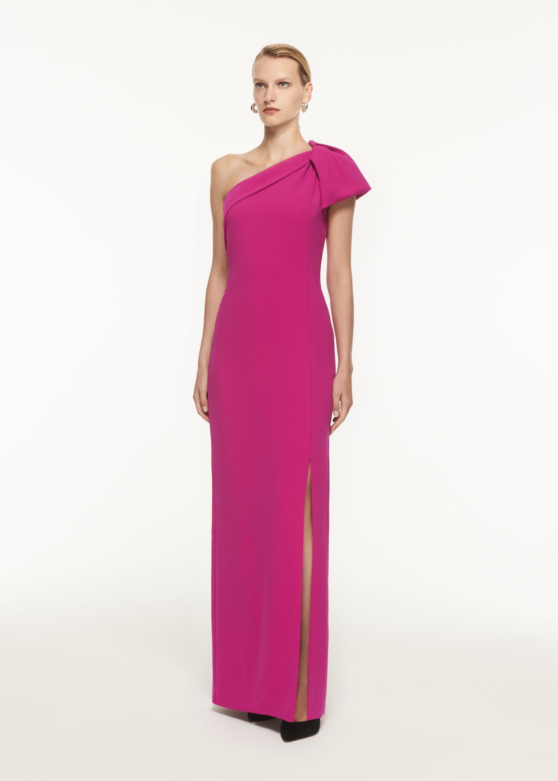 A woman wearing the Asymmetric Bow Stretch Cady Maxi Dress
