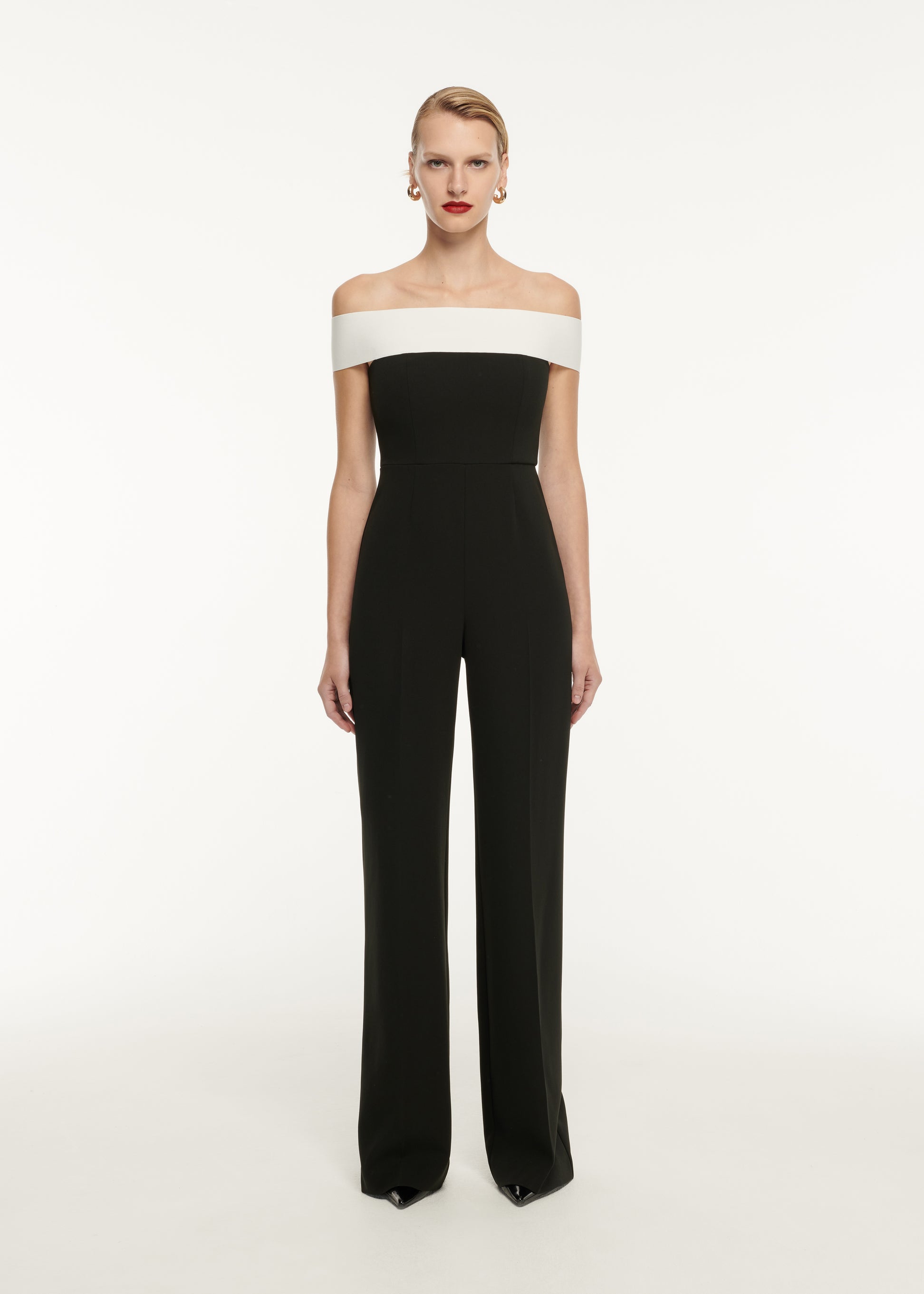 A woman wearing the Off The Shoulder Stretch Cady Jumpsuit