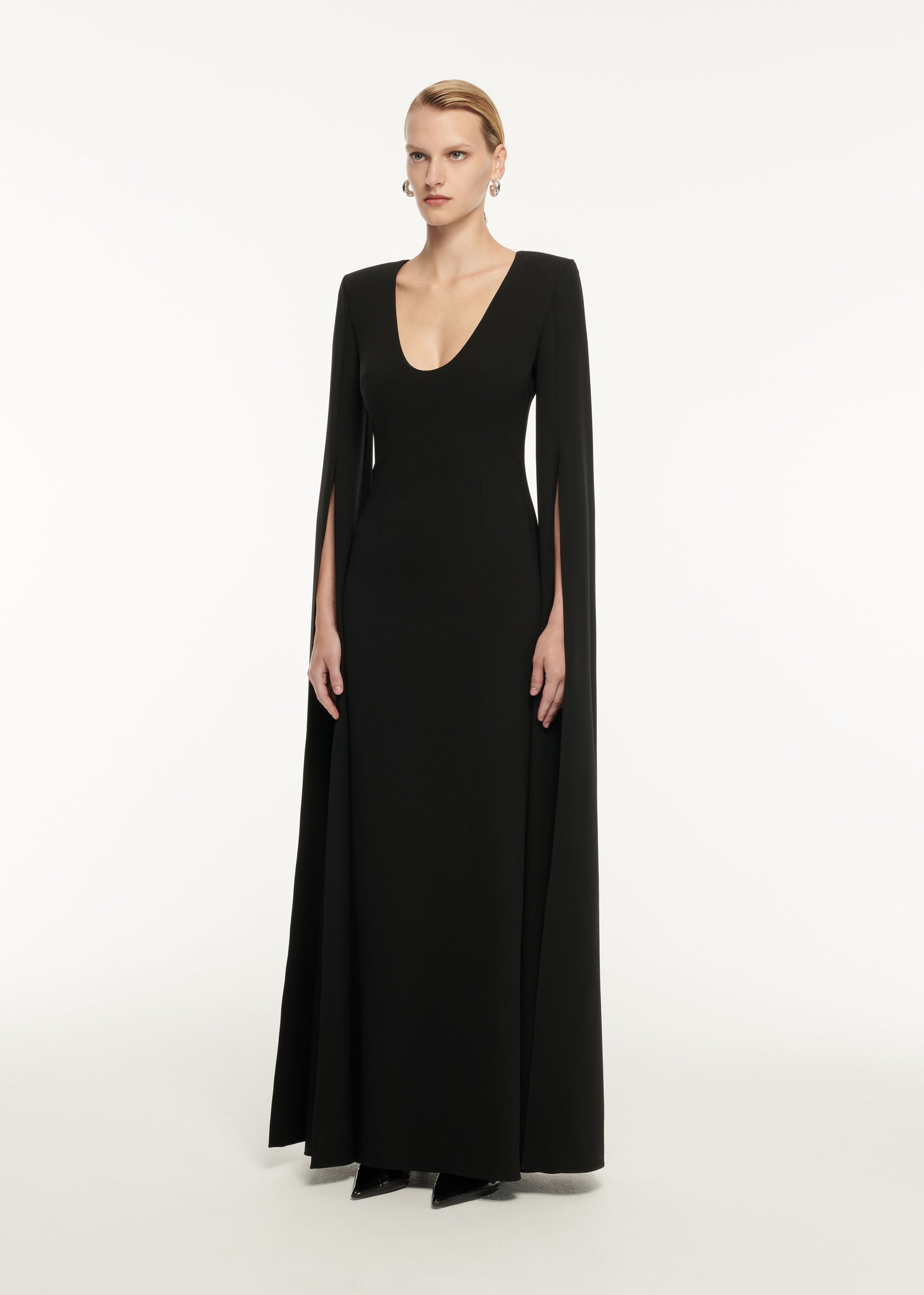 A woman wearing the Cape Sleeve Stretch Cady Maxi Dress