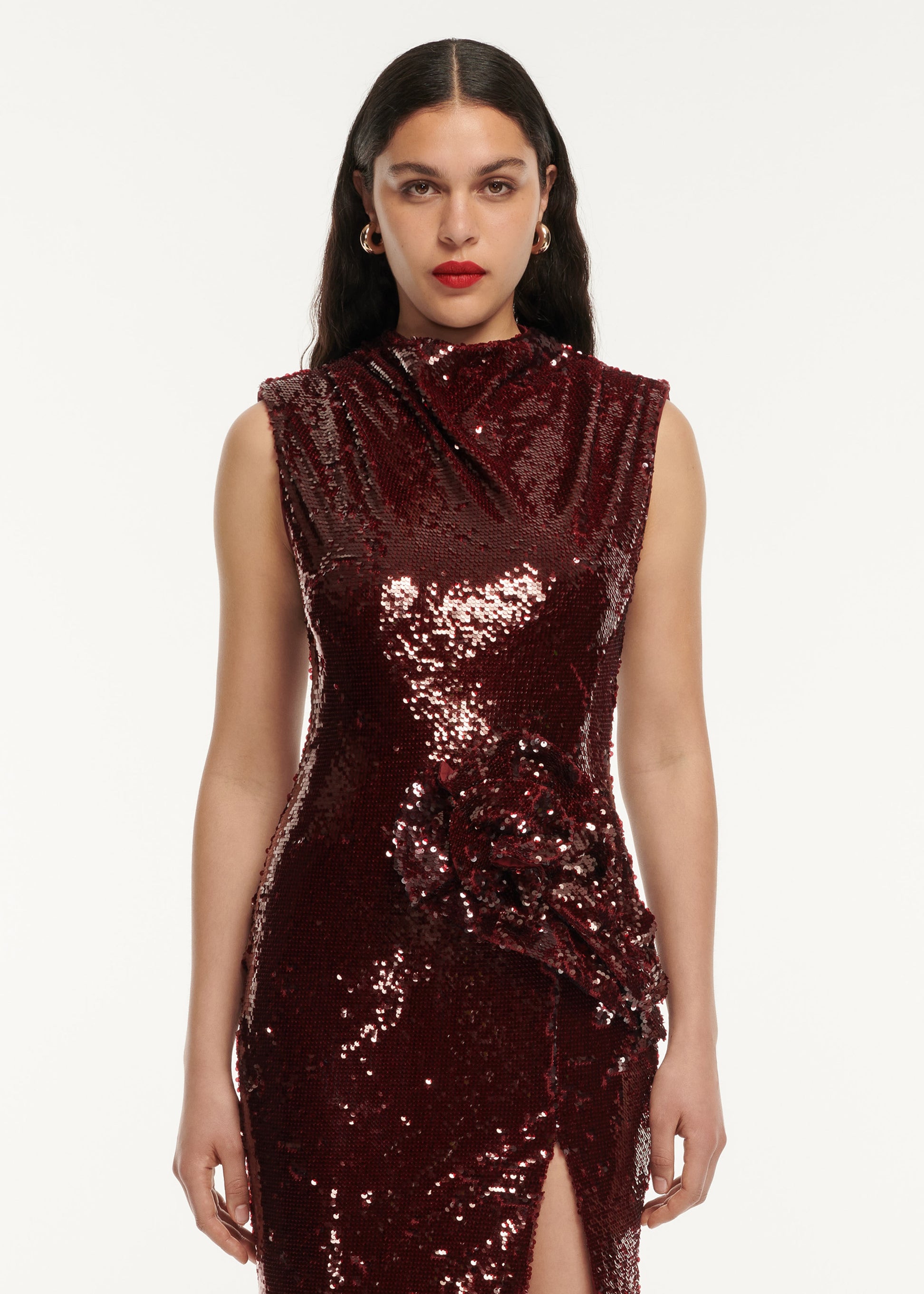 A close up of a woman wearing the Sequin Drape Maxi Dress