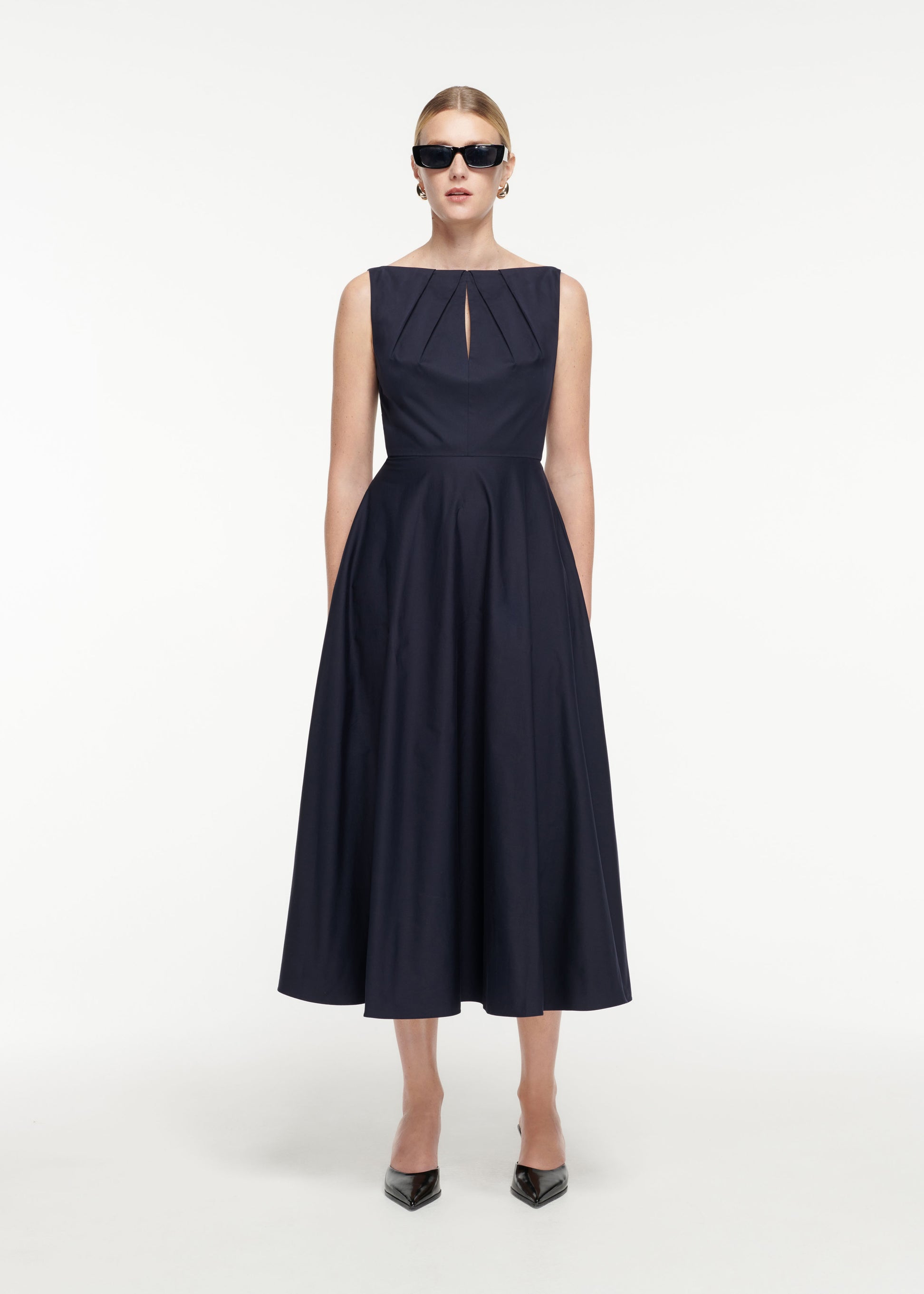 Front view of a model wearing the Cotton Poplin Midi Dress in Navy