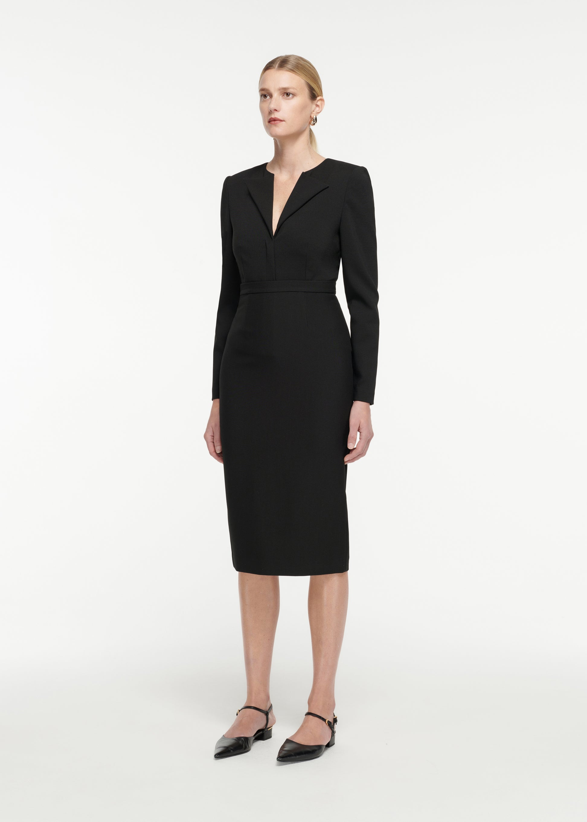 Side view of a model wearing the Crepe Midi Skirt in Black