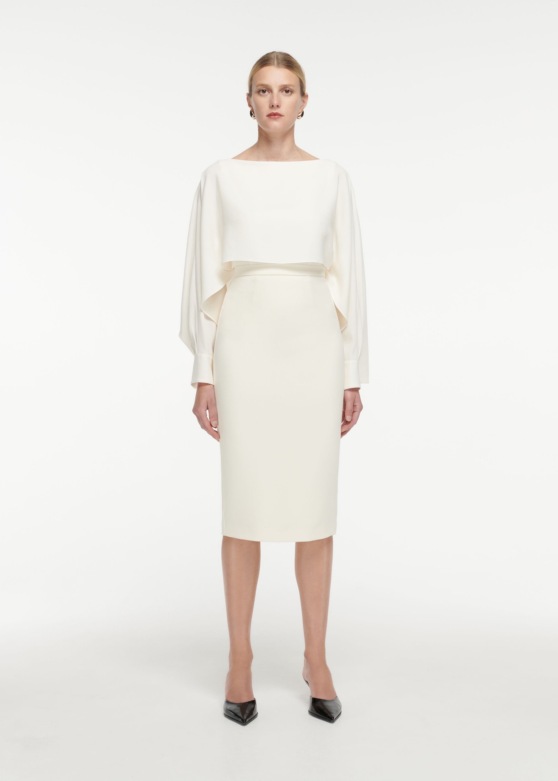 Front view of a model wearing the Crepe Midi Skirt in Cream