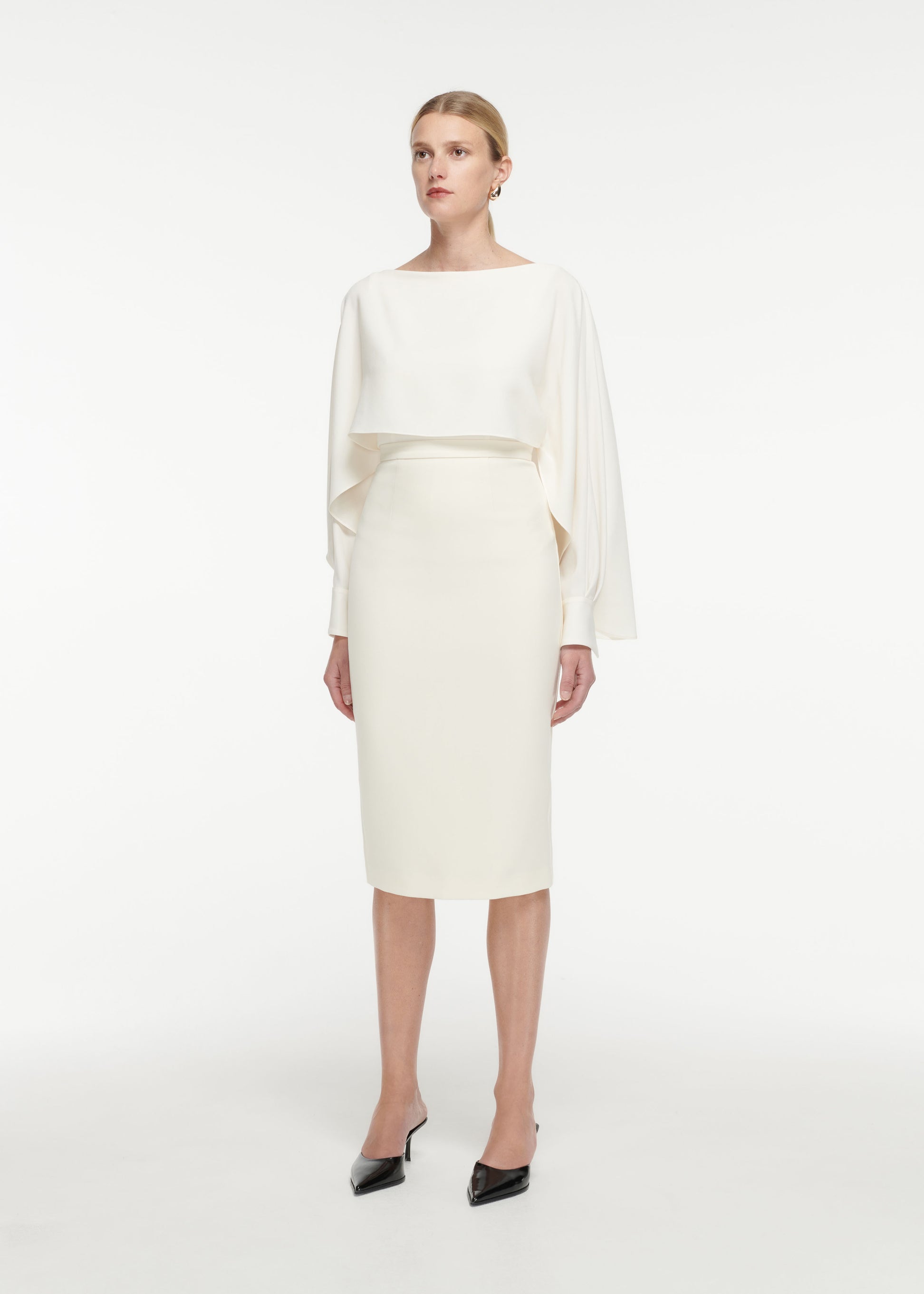 Side view of a model wearing the Crepe Midi Skirt in Cream