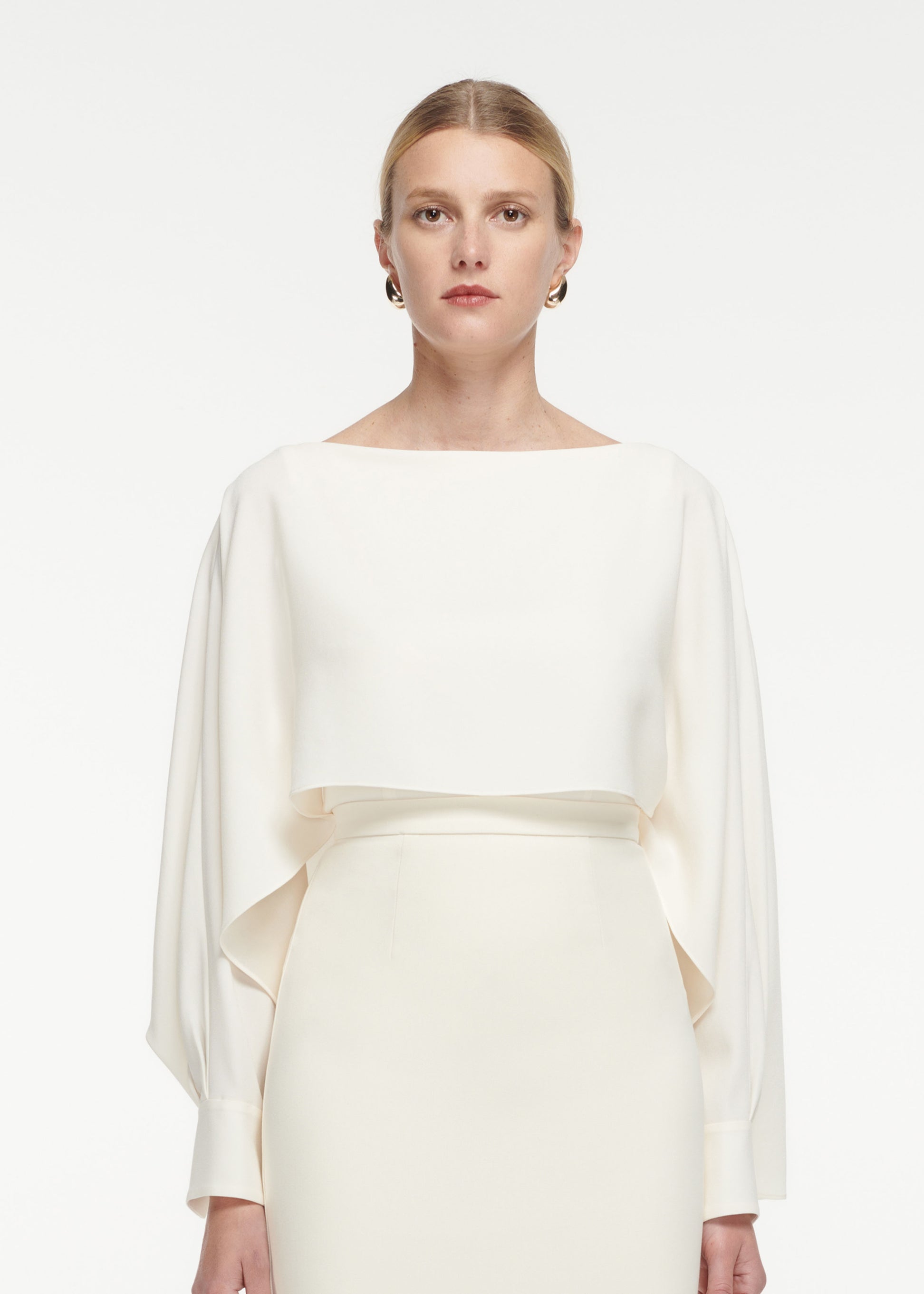 Close up of a model wearing the Crepe Midi Skirt in Cream