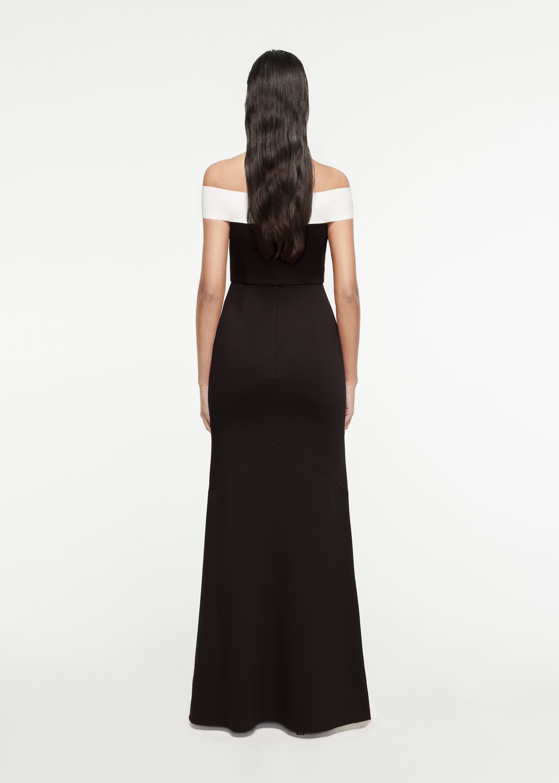 The back of a woman wearing the Off-The-Shoulder Stretch-Cady Gown in Black