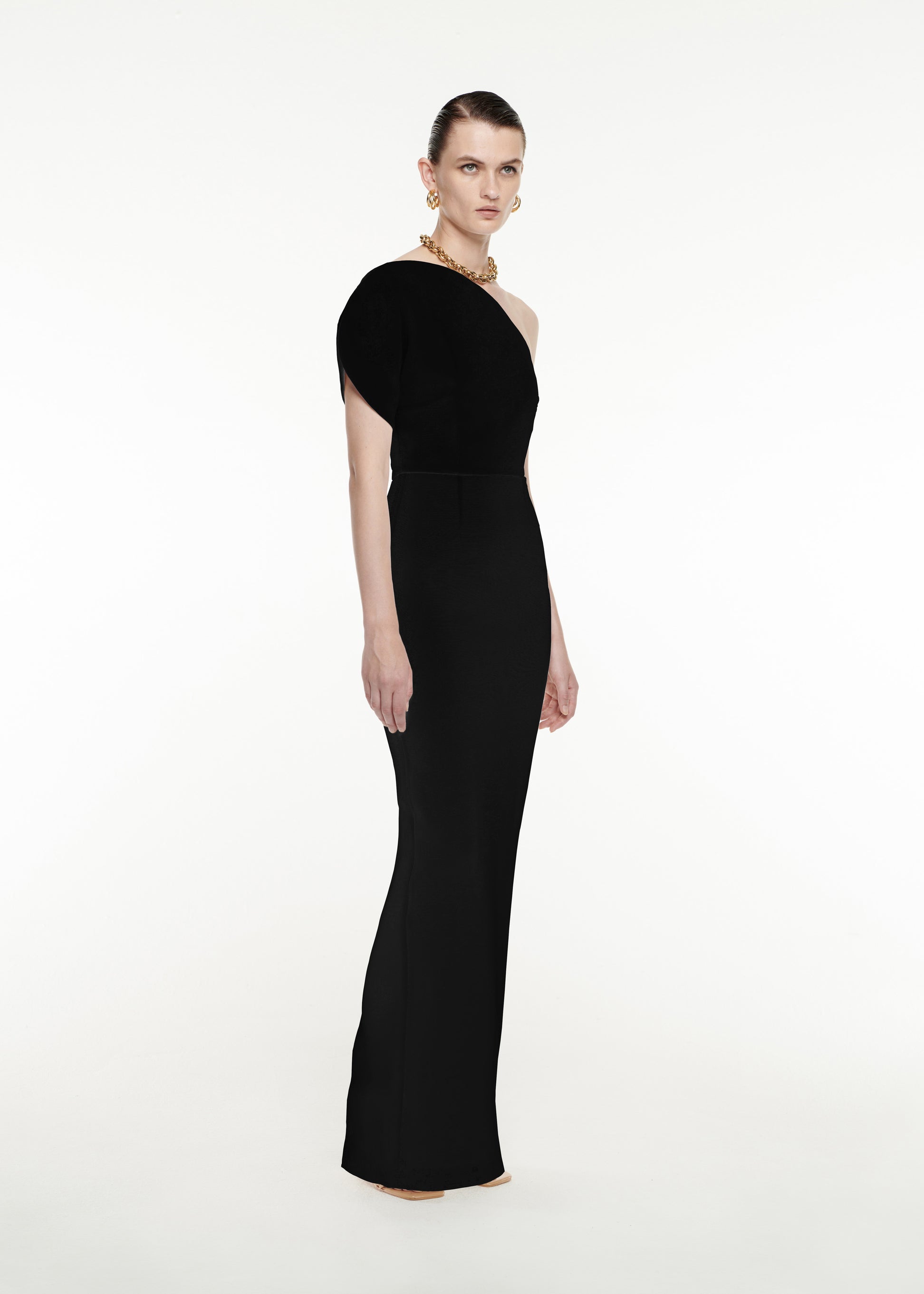 Woman wearing the Asymmetric Silk Wool Maxi Dress in Black