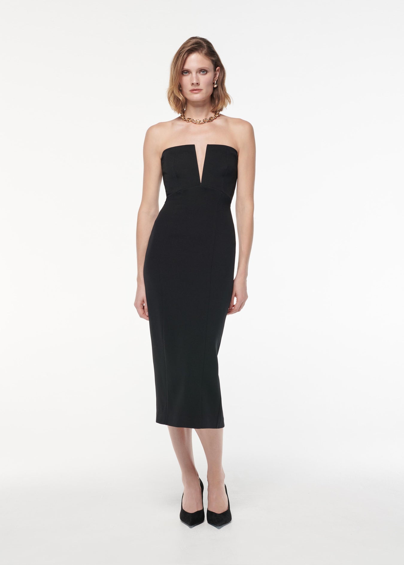 A photograph of a woman wearing a Strapless Stretch Wool Silk Midi Dress in Black