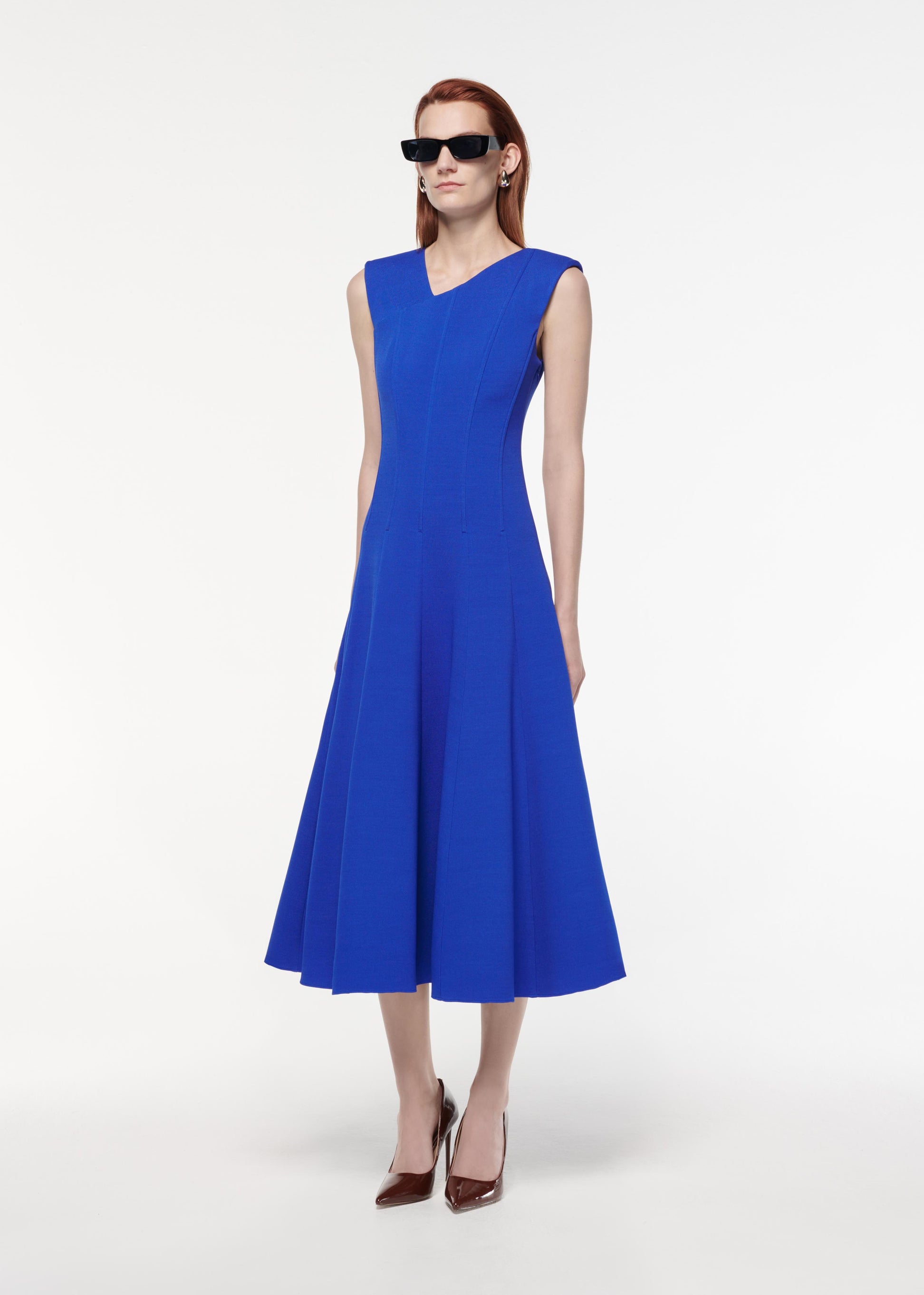 A photograph of a woman wearing a Stretch Wool Silk Midi Dress in Blue