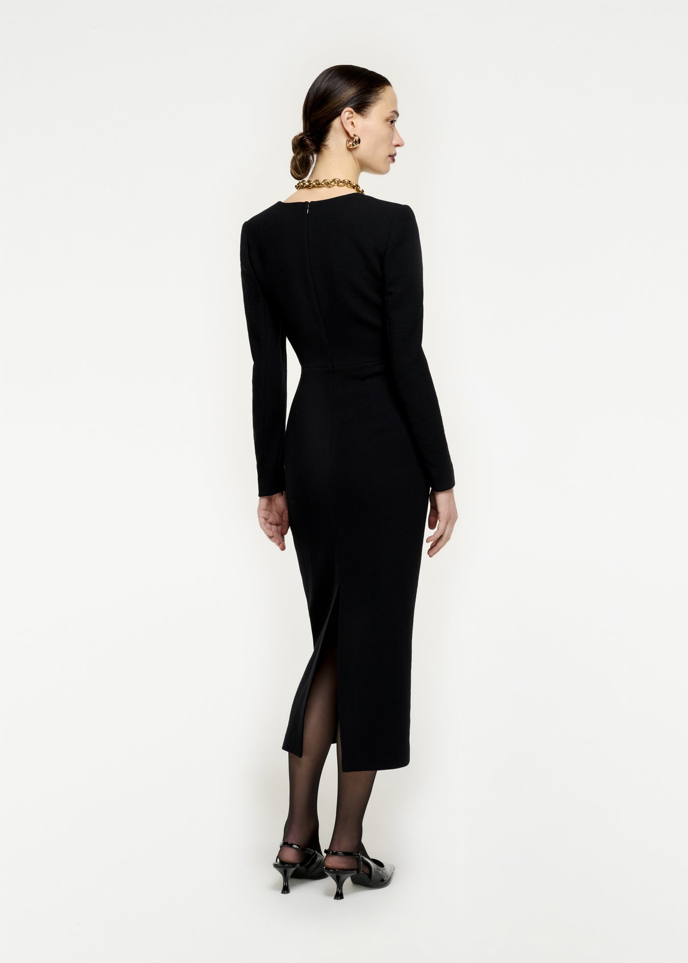 The back of a woman wearing the Long Sleeve Wool Crepe Midi Dress in Black