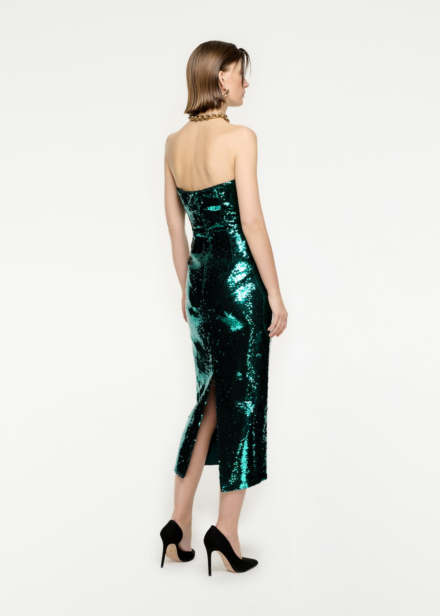 The back of a woman wearing the Strapless Sequin Midi Dress in Green