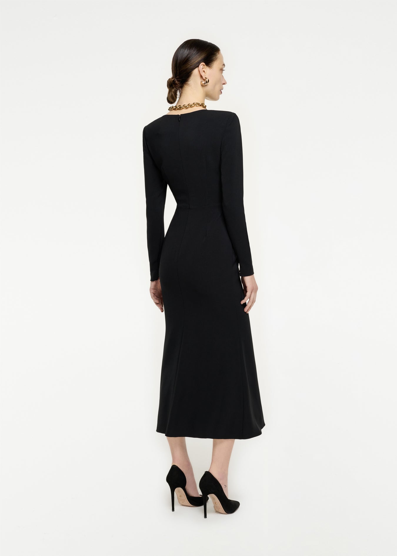 The back of a woman wearing the Long Sleeve Stretch Cady Midi Dress in Black