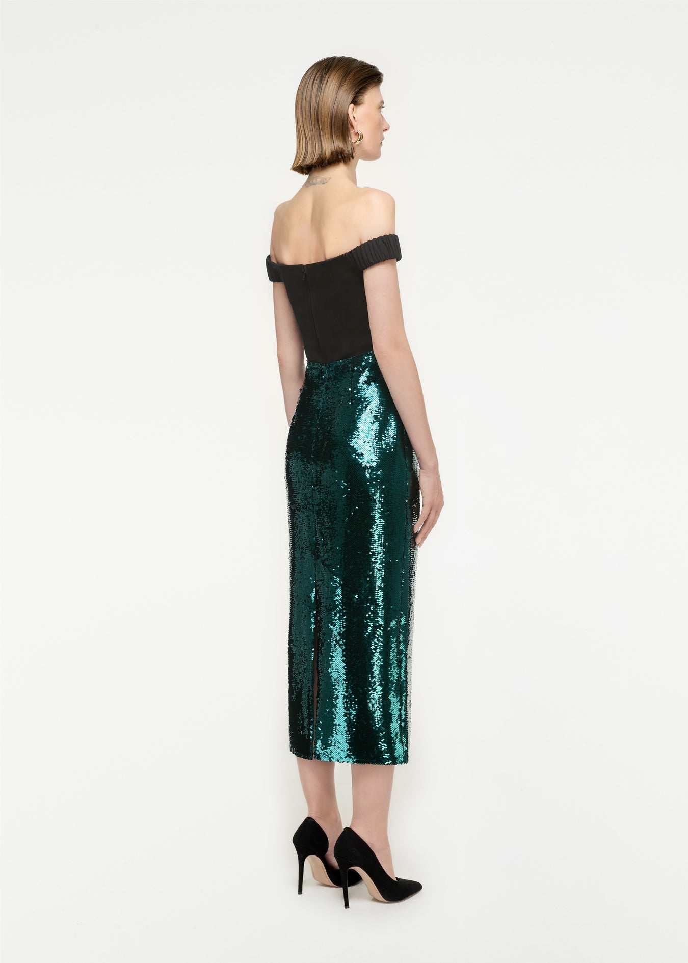 The back of a woman wearing the Sequin Midi Skirt in Green