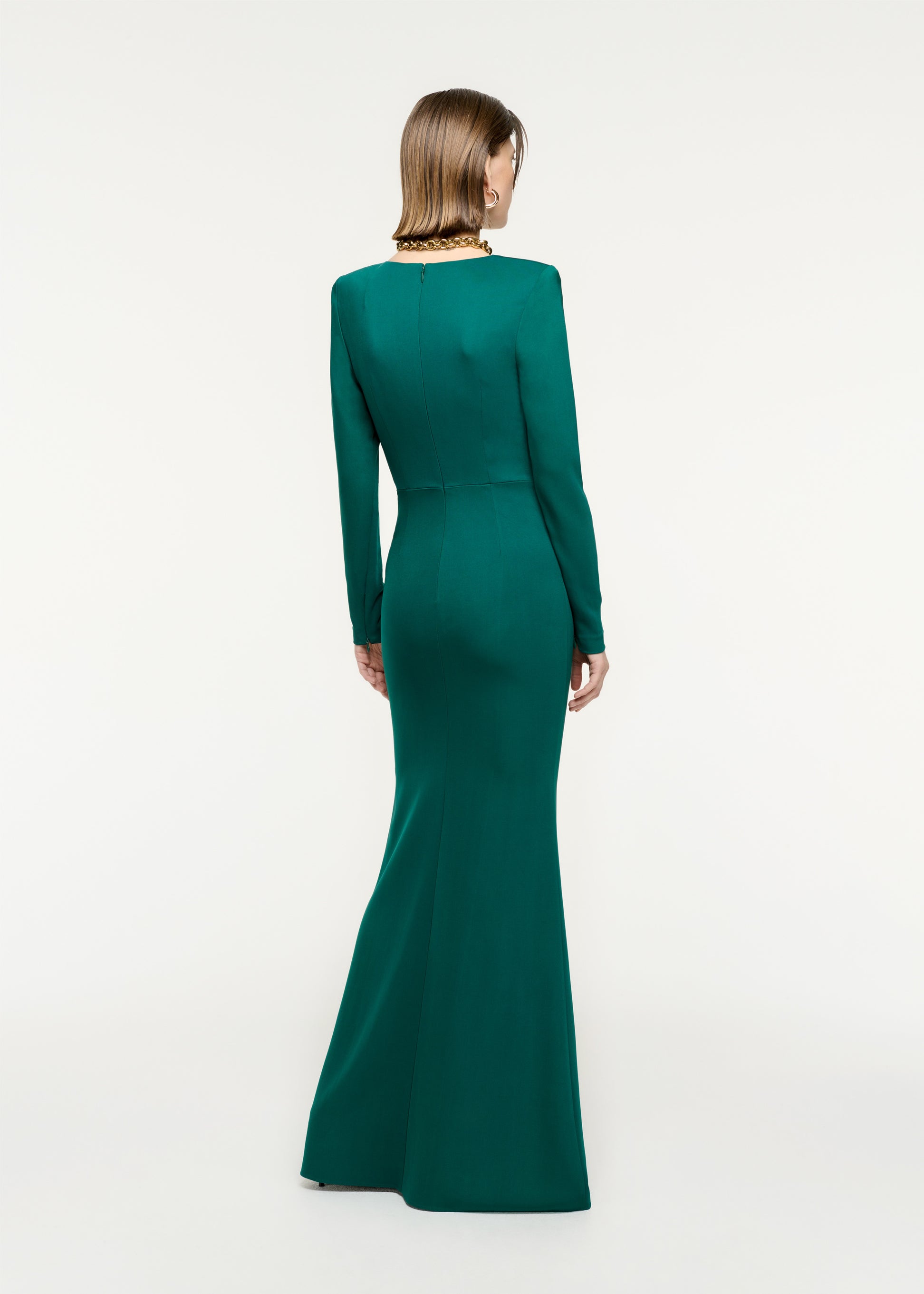 The back of a woman wearing the Long Sleeve Stretch Cady Maxi Dress in Green