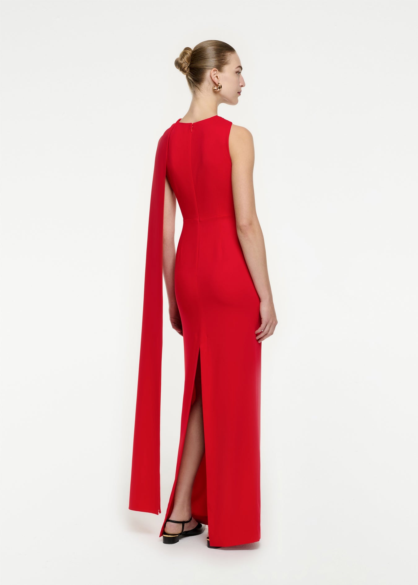 The back of a woman wearing the Asymmetric Stretch Cady Maxi Dress in Red