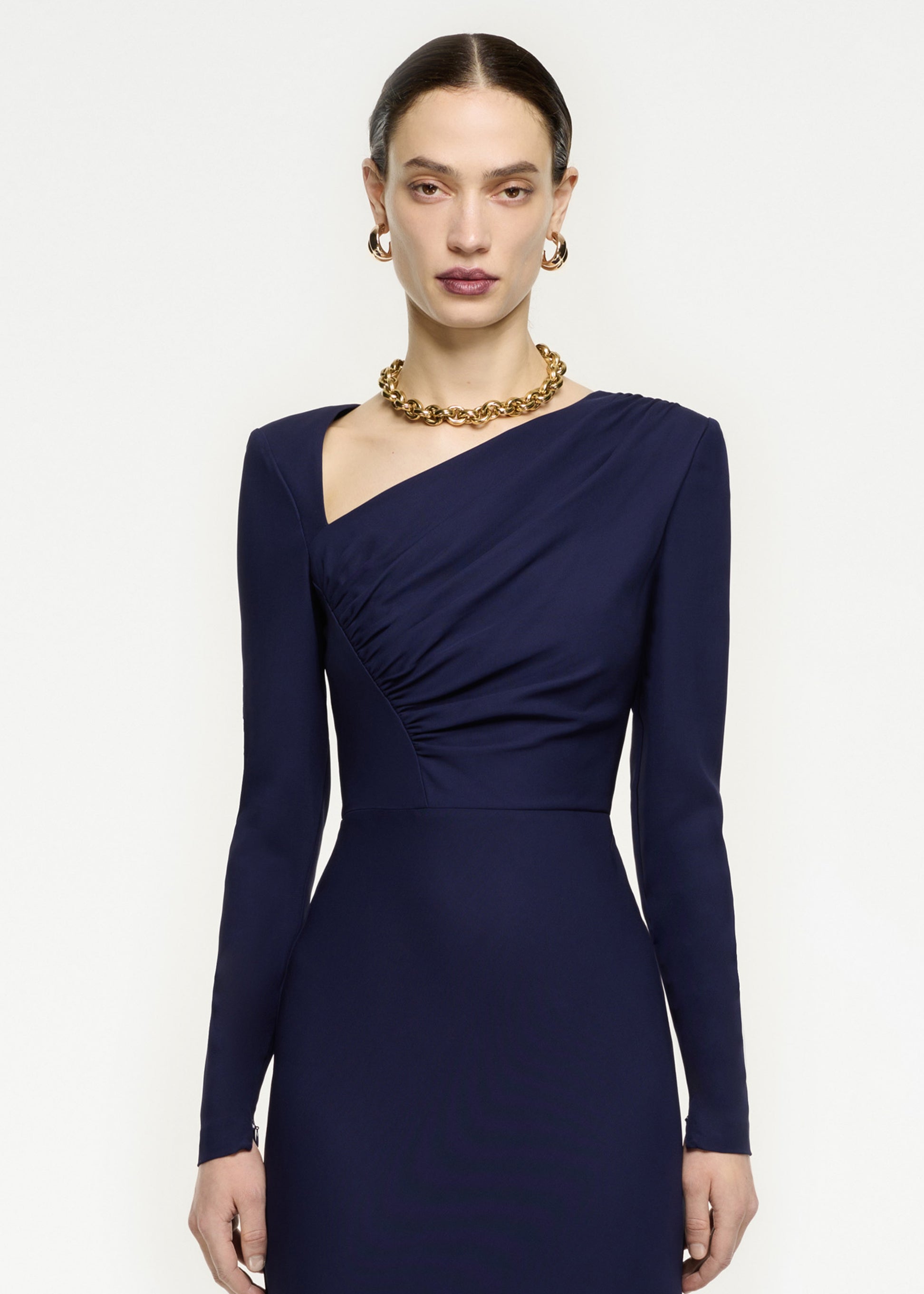 A close up of a woman wearing the Long Sleeve Stretch Cady Midi Dress in Navy