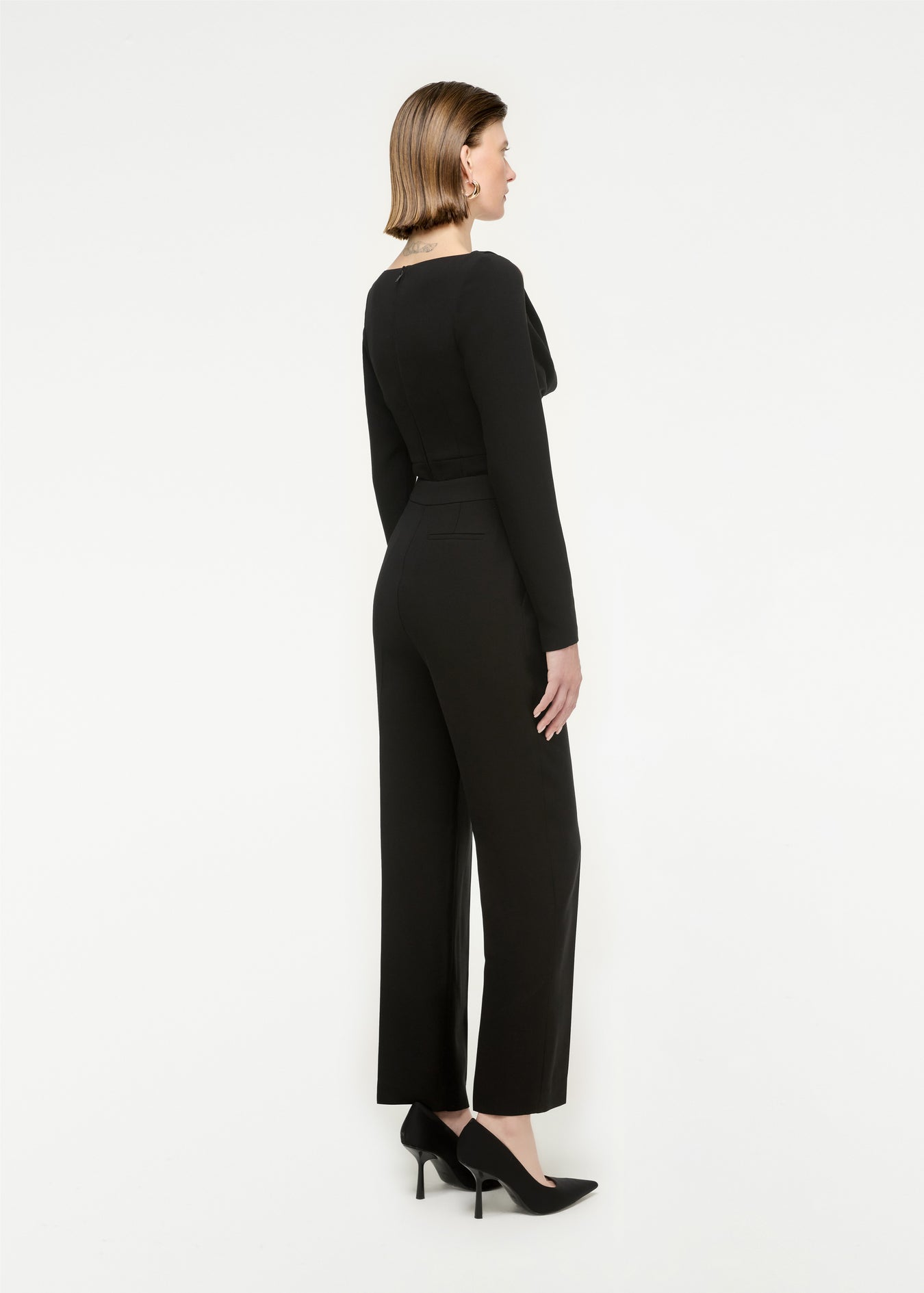 The back of a woman wearing the Long Sleeve Stretch Cady Top in Monochrome