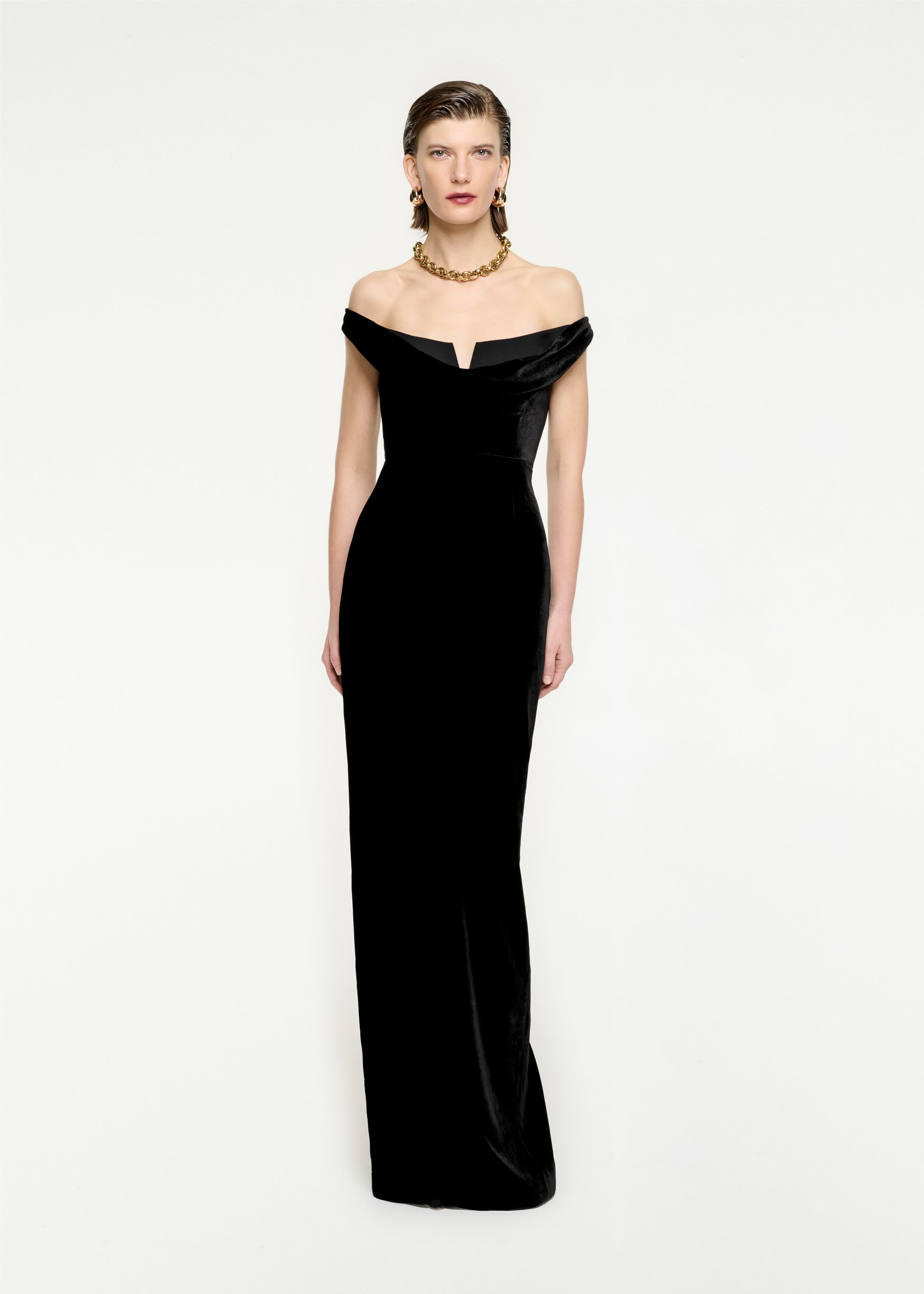 Woman wearing the Off The Shoulder Velvet Maxi Dress in Black