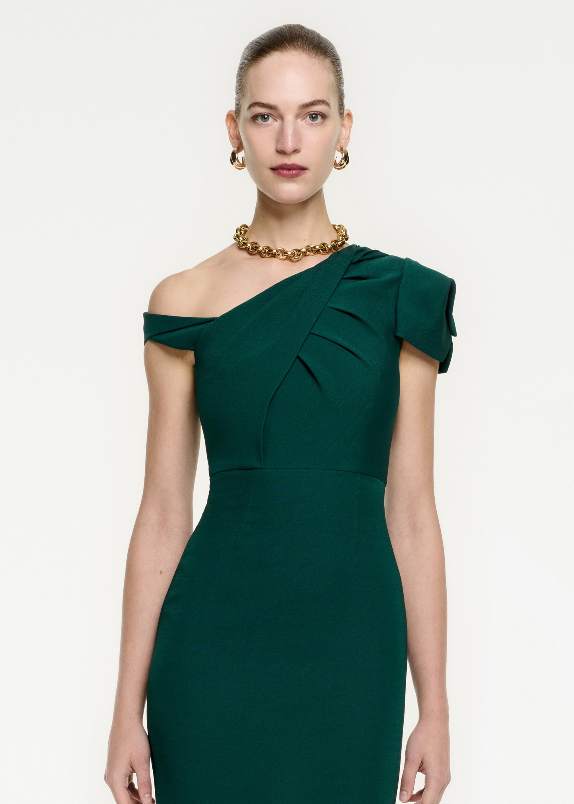 A close up of a woman wearing the Asymmetric Wool Silk Midi Dress in Green