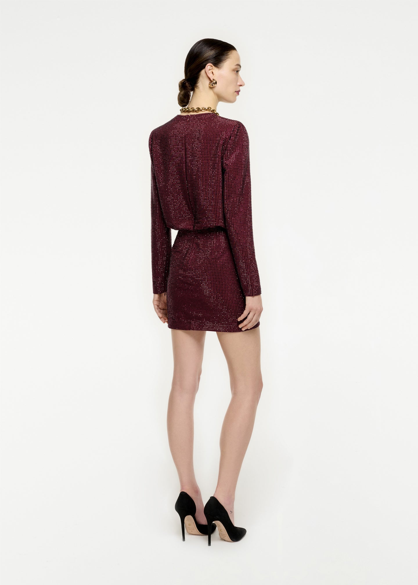 The back of a woman wearing the Long Sleeve Diamante Mini Dress in Maroon