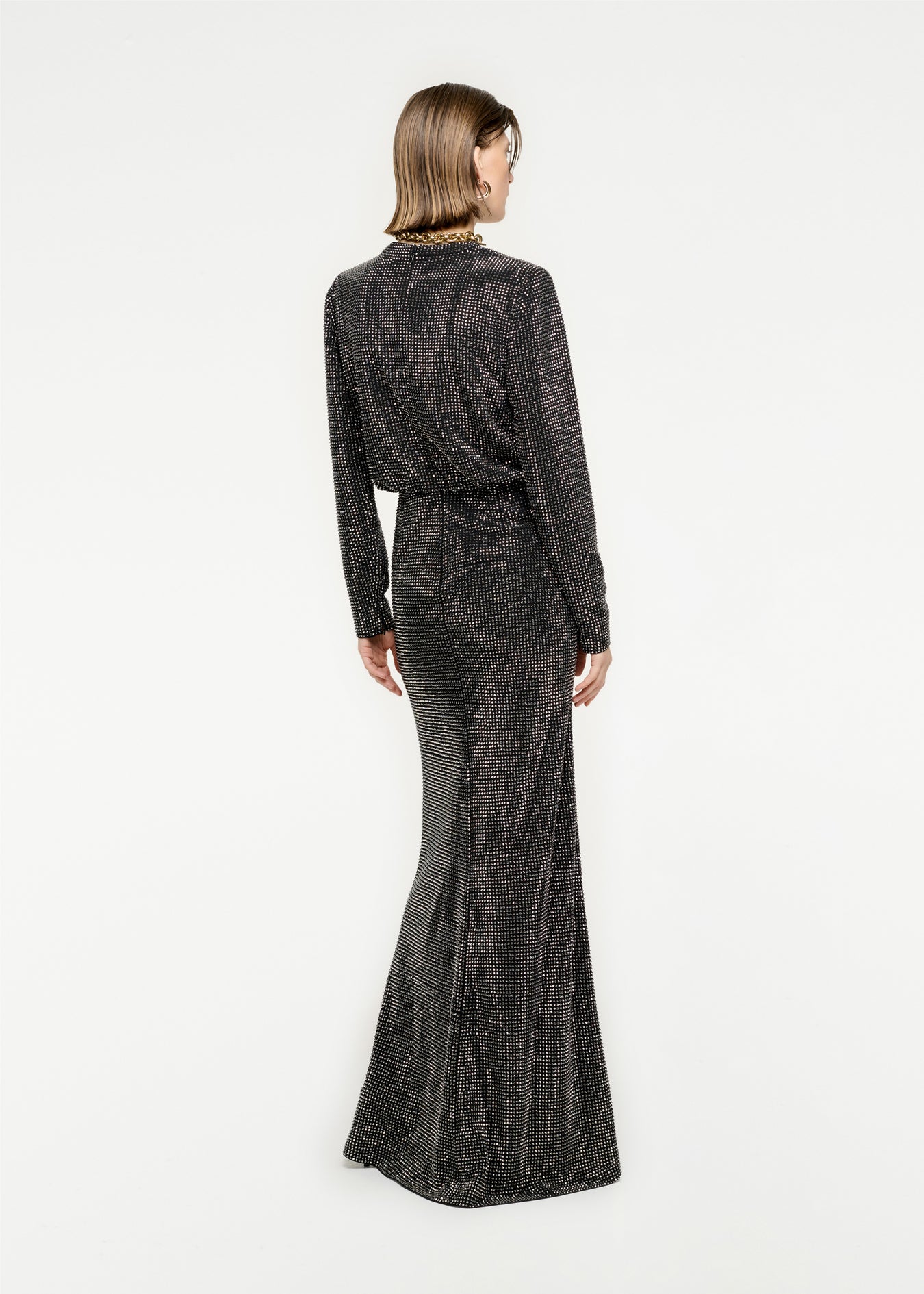 The back of a woman wearing the Long Sleeve Diamante Maxi Dress in Black