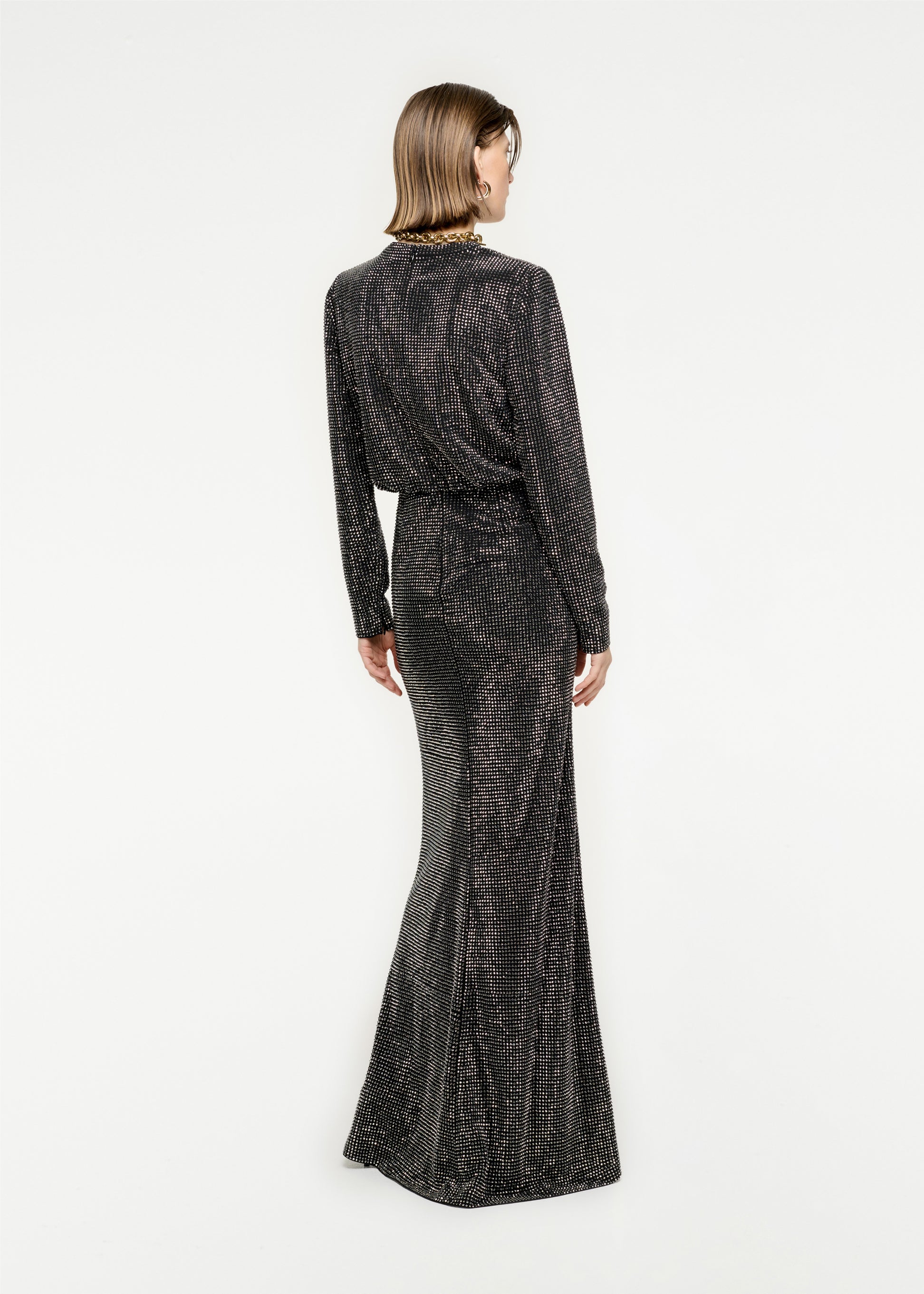 The back of a woman wearing the Long Sleeve Diamante Maxi Dress in Black