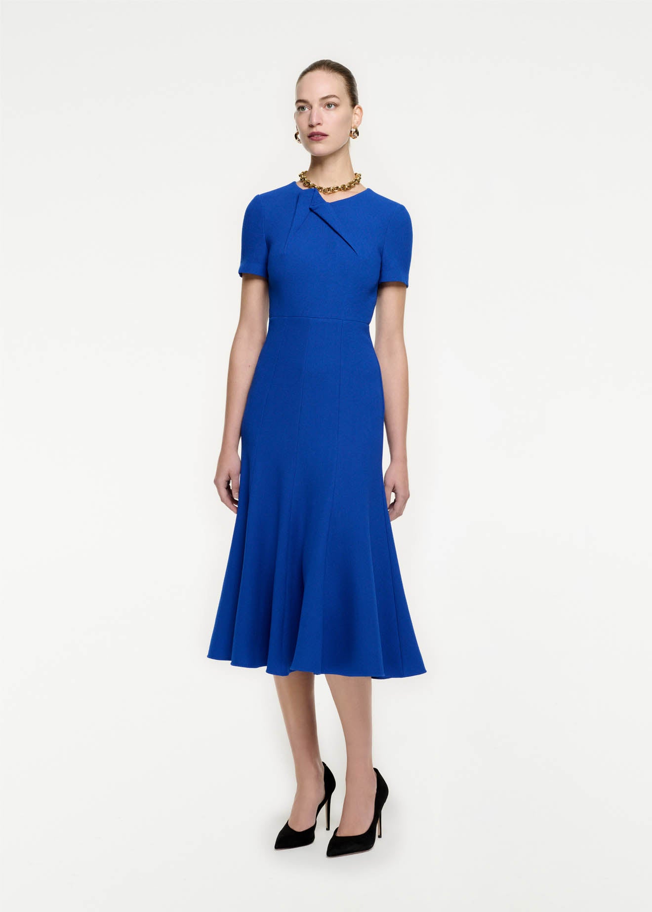 Side view of a model wearing the Short Sleeve Wool Crepe Midi Dress in Blue