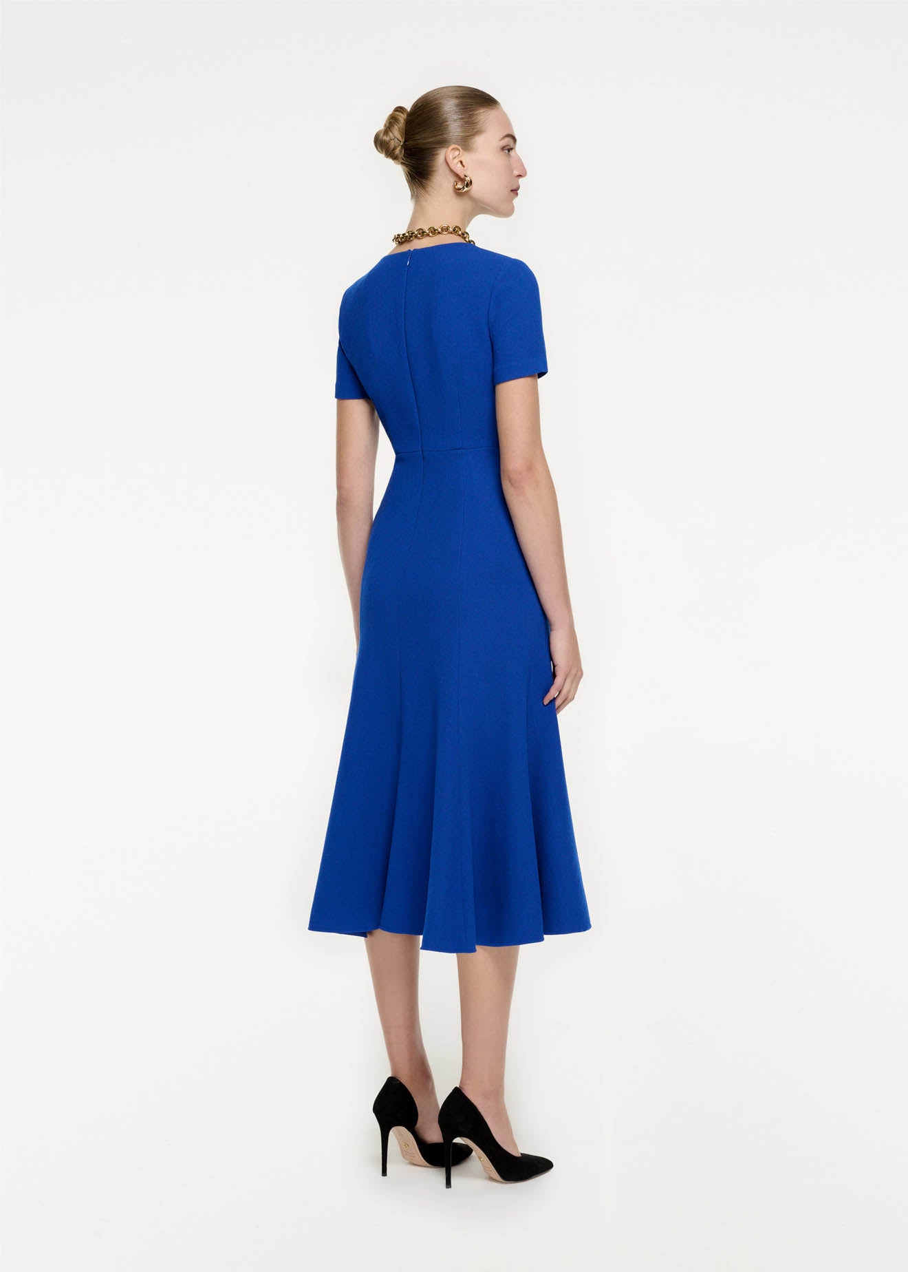 Back view of a model wearing the Short Sleeve Wool Crepe Midi Dress in Blue