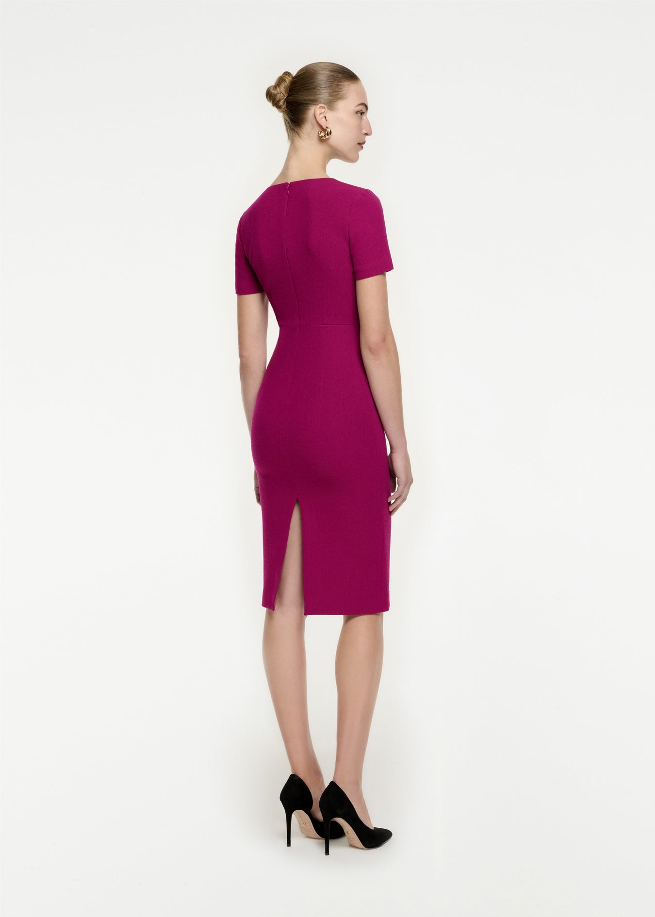 The back of a woman wearing the Short Sleeve Wool Crepe Midi Dress in Purple