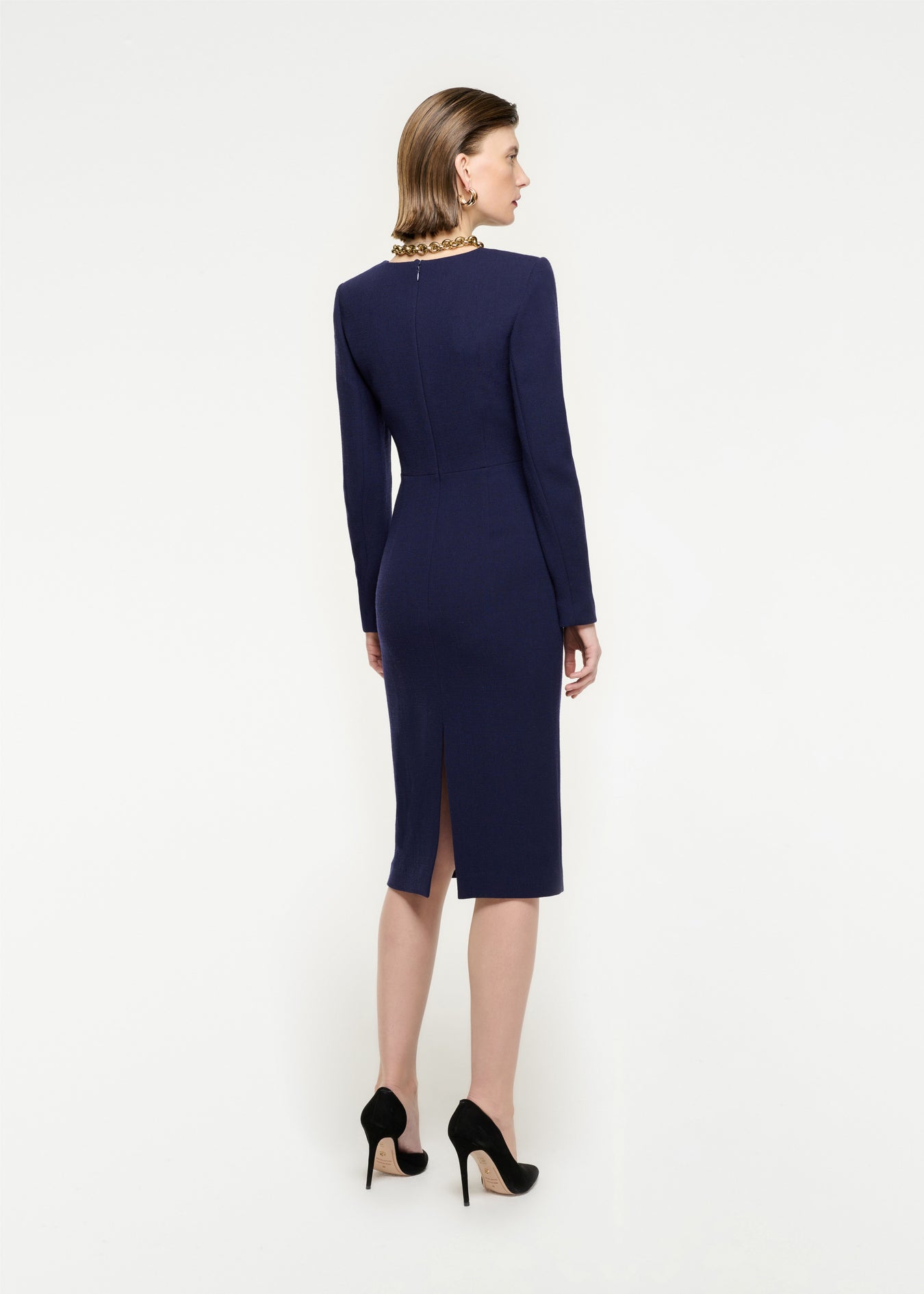 The back of a woman wearing the Long Sleeve Wool Crepe Midi Dress in Navy