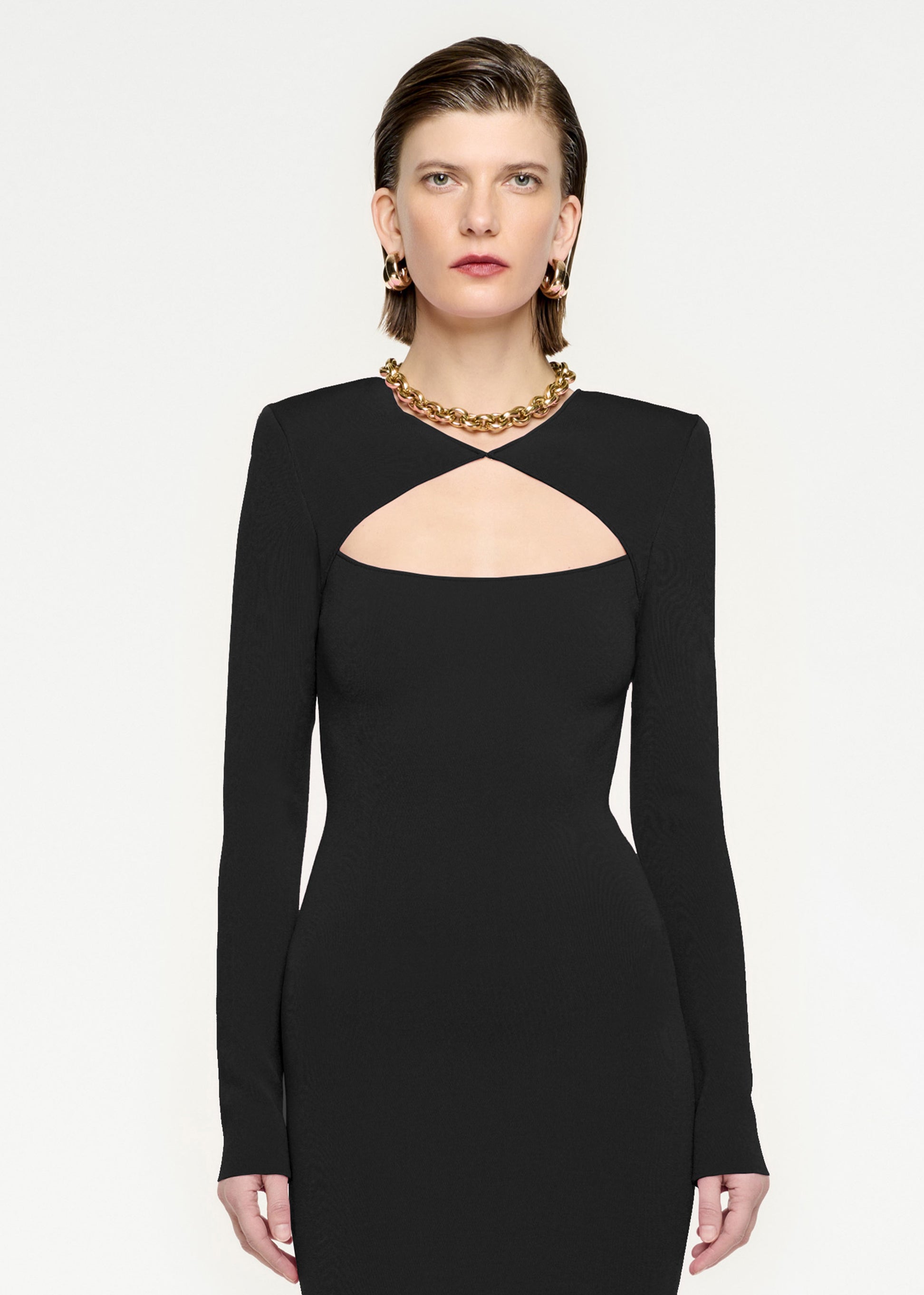 A close up of a woman wearing the Long Sleeve Knit Midi Dress in Black