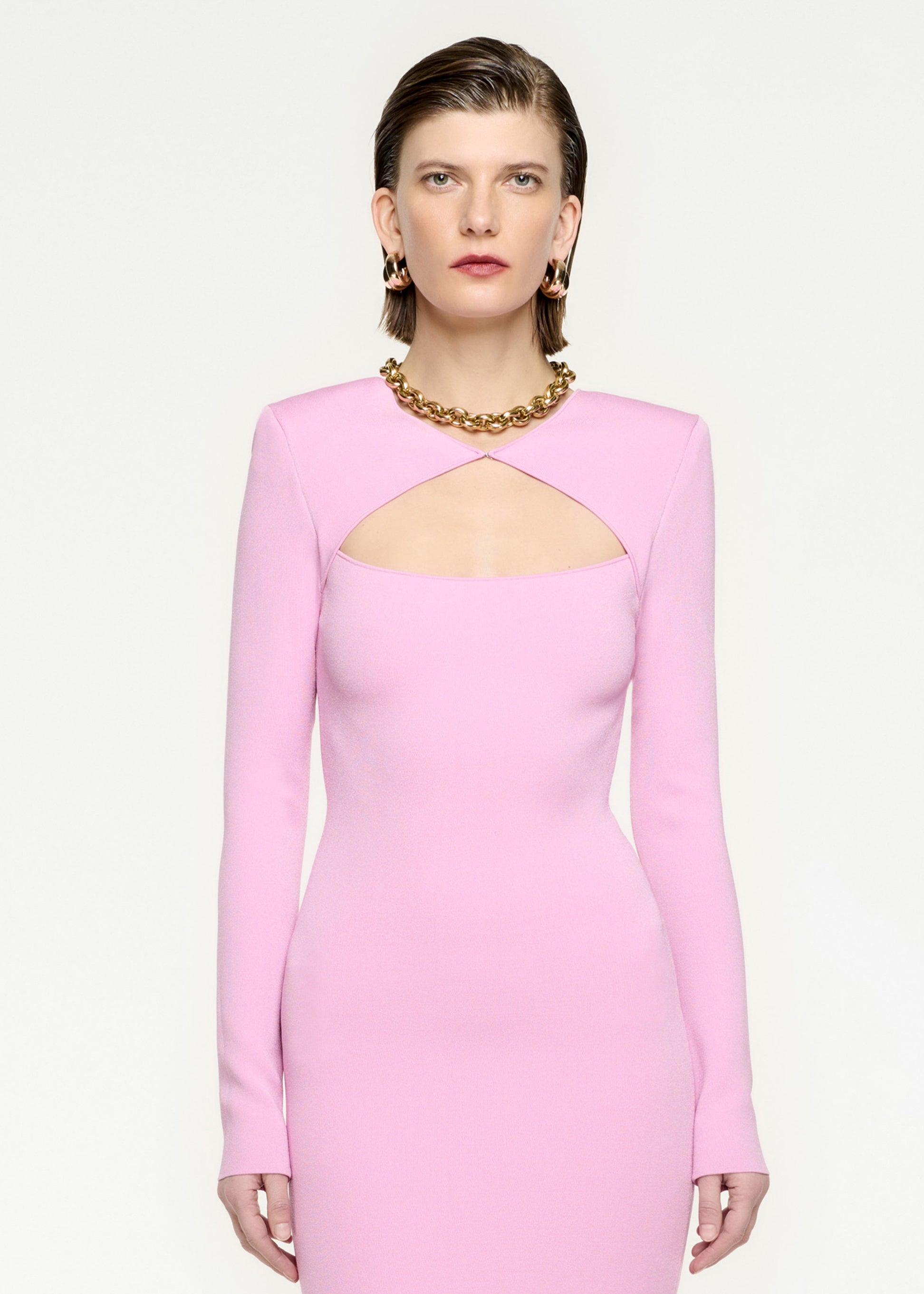 A close up of a woman wearing the Long Sleeve Knit Midi Dress in Pink