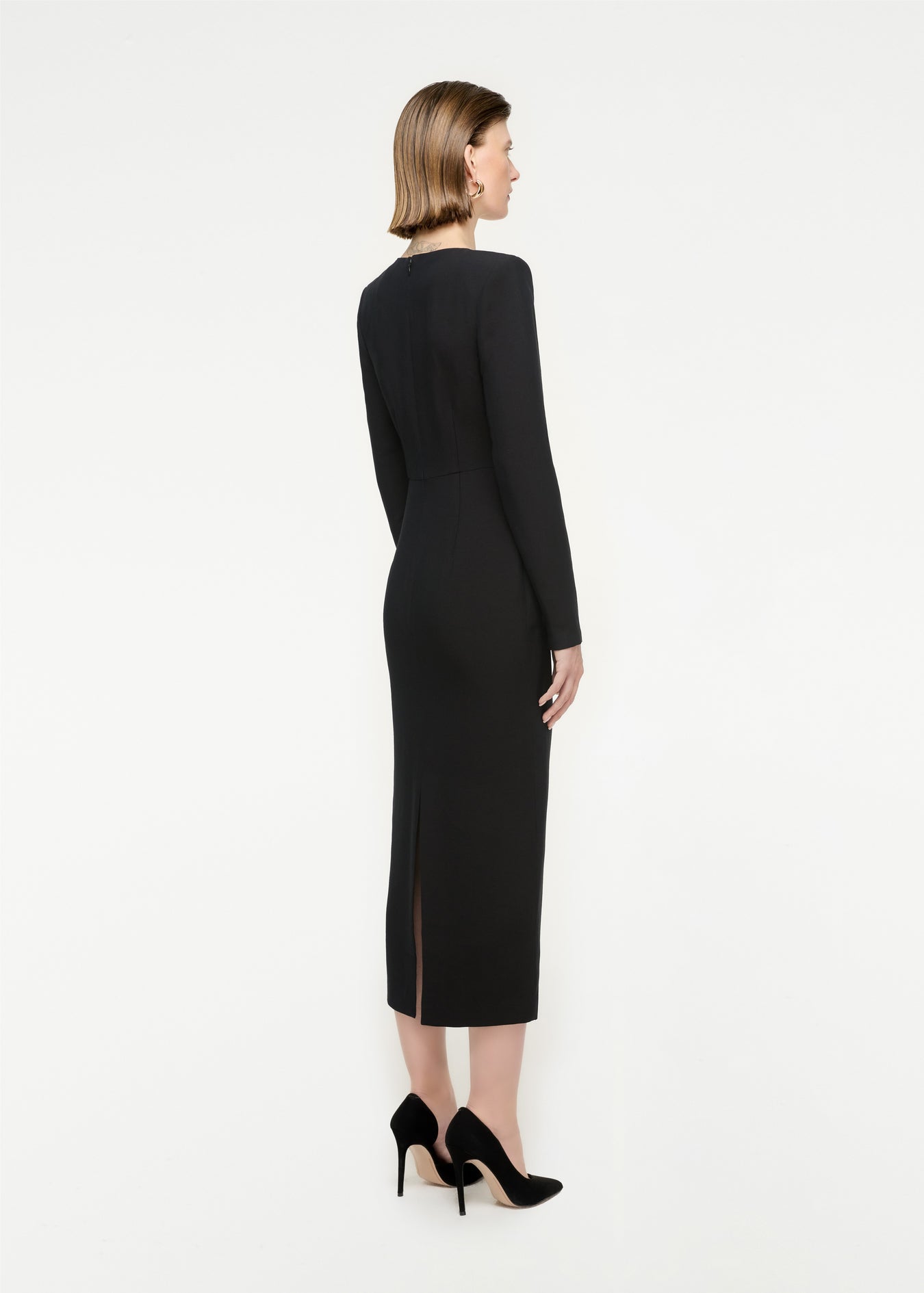 The back of a woman wearing the Long Sleeve Wool Silk Midi Dress in Black