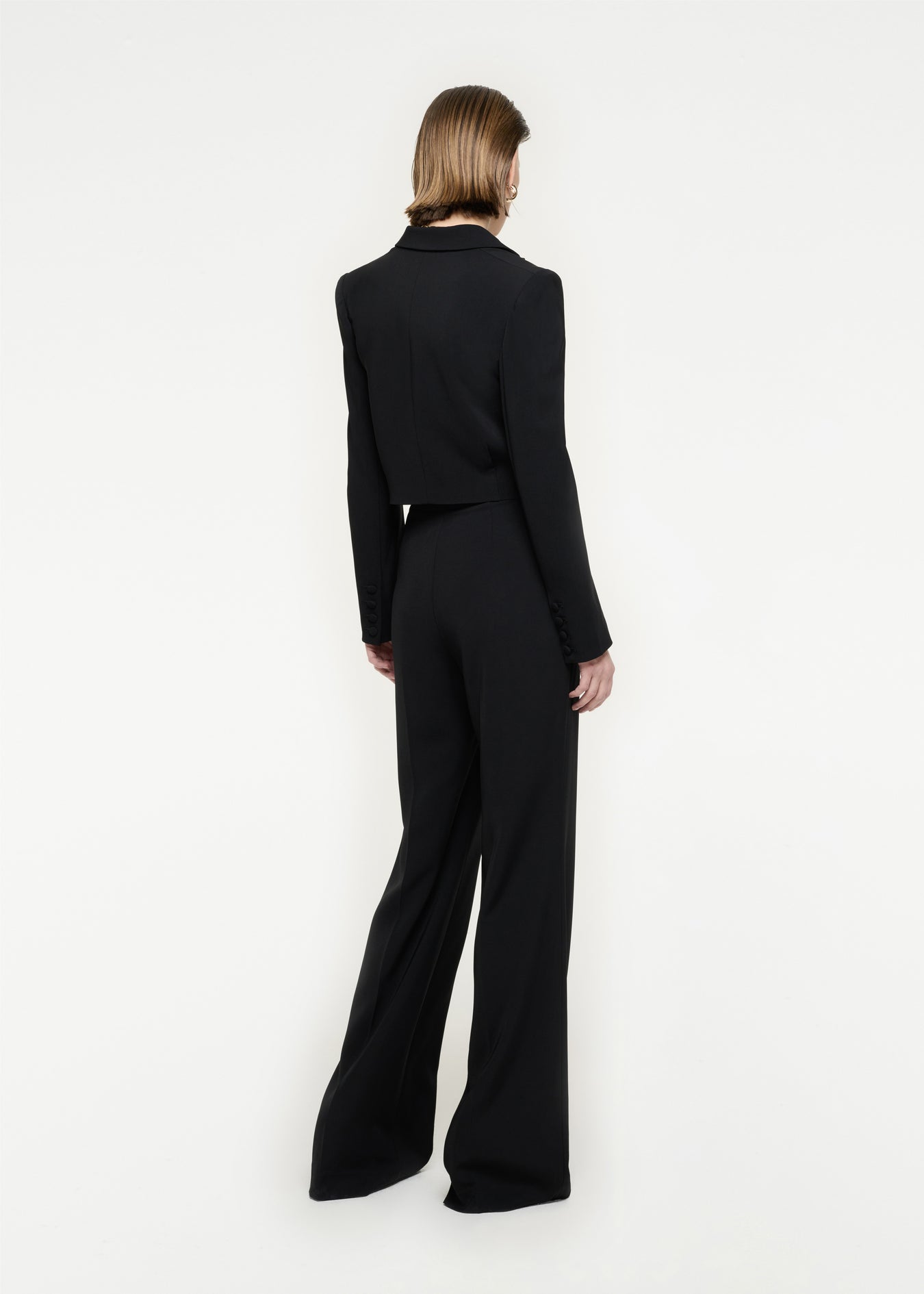 The back of a woman wearing the Wide Leg Stretch Cady Trouser in Black