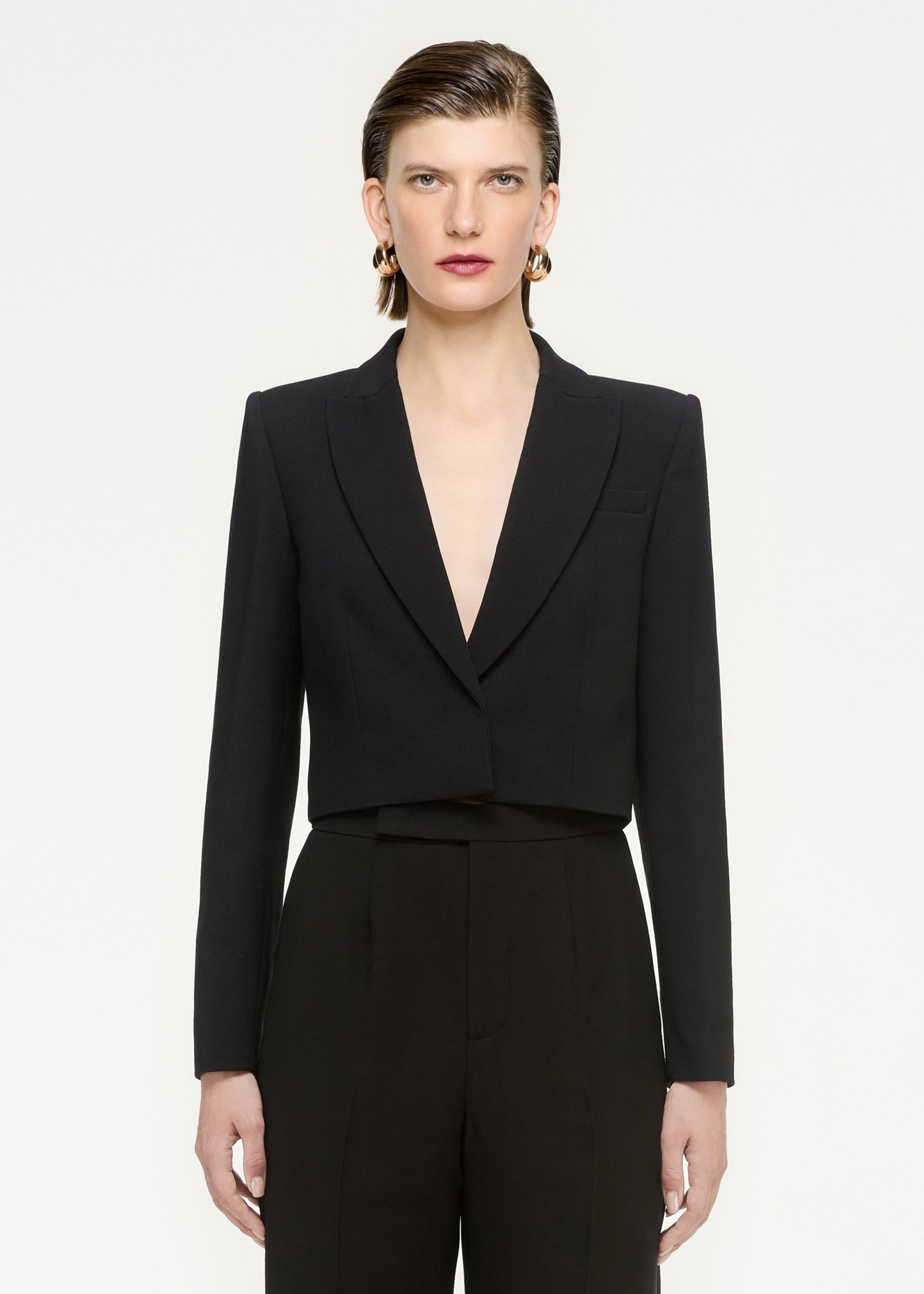 A close up of a woman wearing the Wool Silk Cropped Jacket in Black