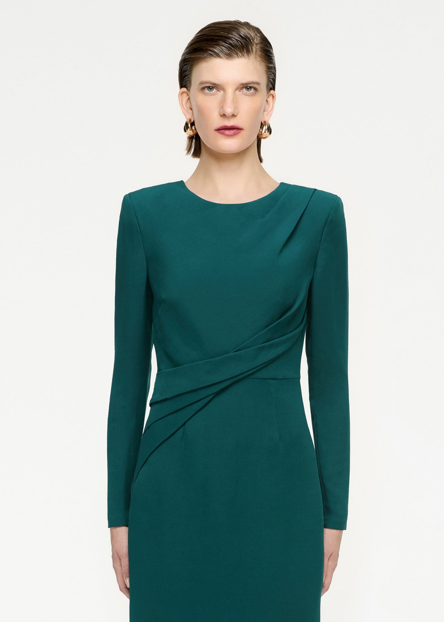 A close up of a woman wearing the Long Sleeve Wool Silk Midi Dress in Green