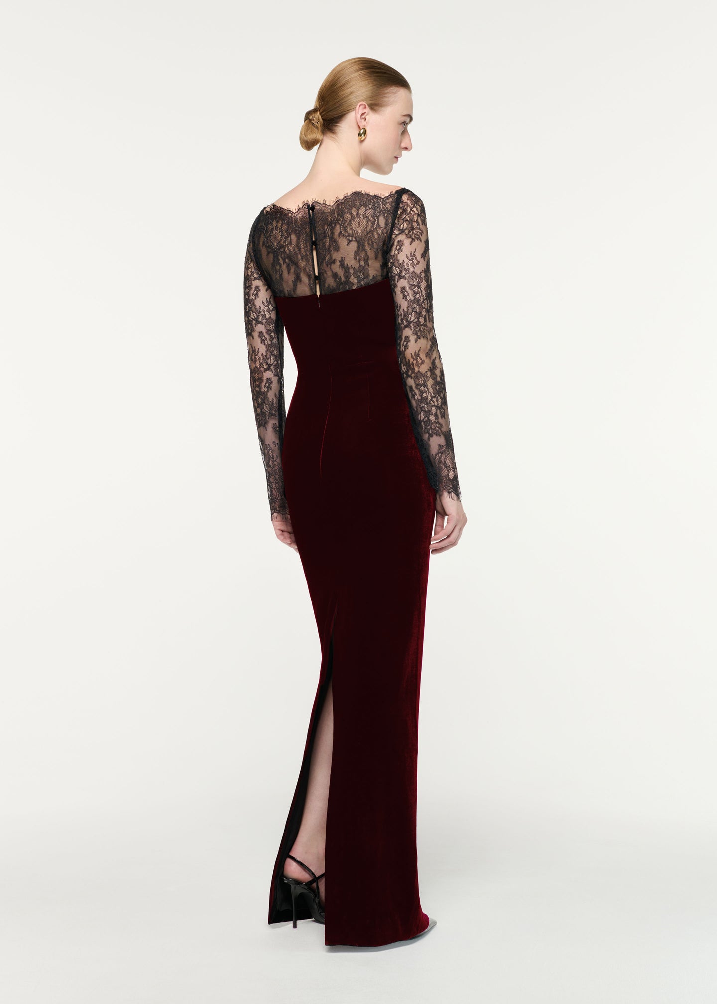 Back view of a model wearing the Scalloped Lace And Velvet Gown