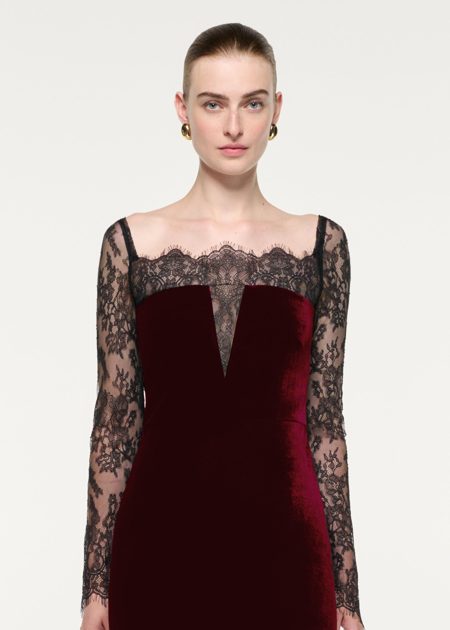 Close up of a model wearing the Scalloped Lace And Velvet Gown