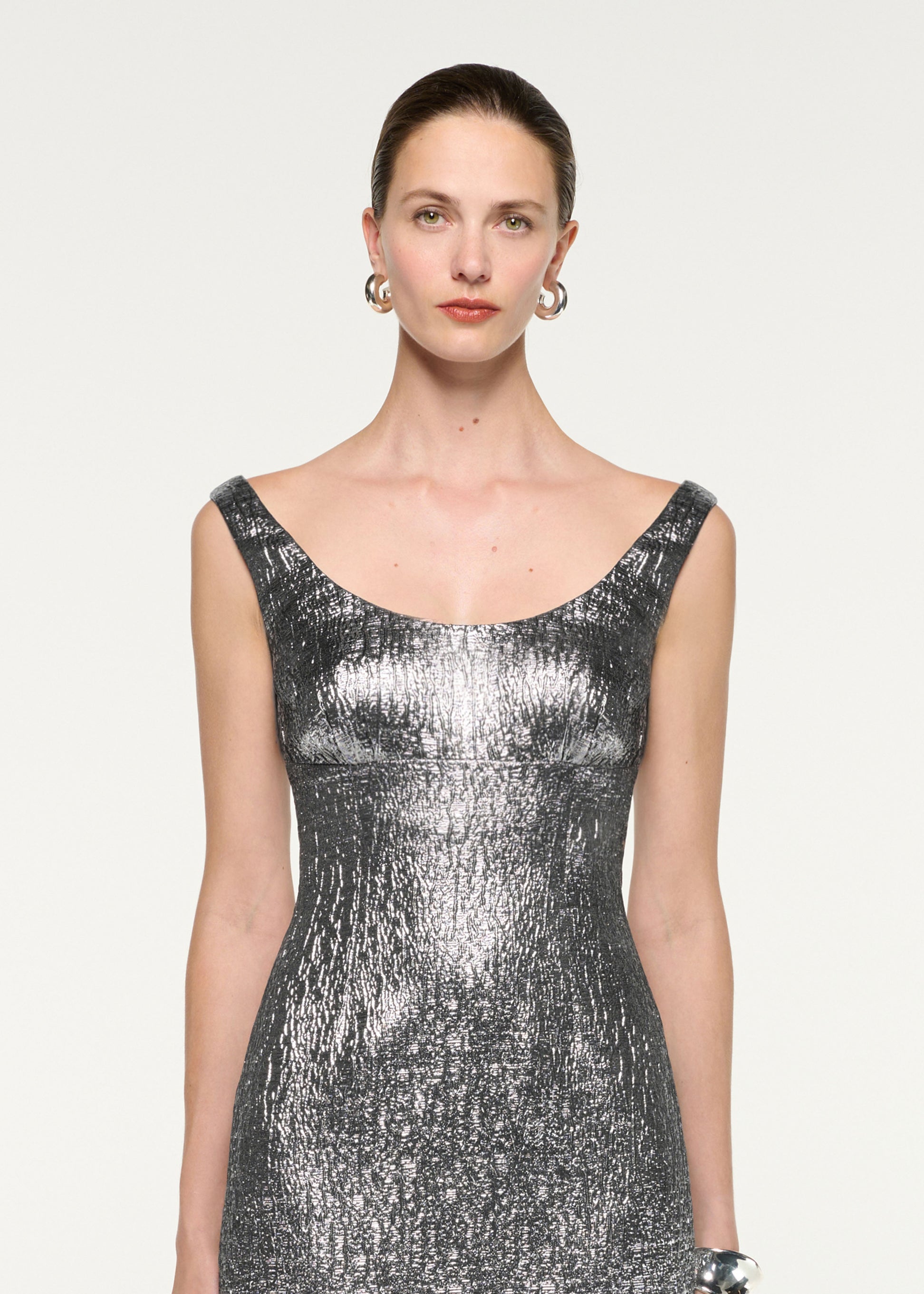 Close up of a model wearing the Metallic Jaquard Column Midi Dress