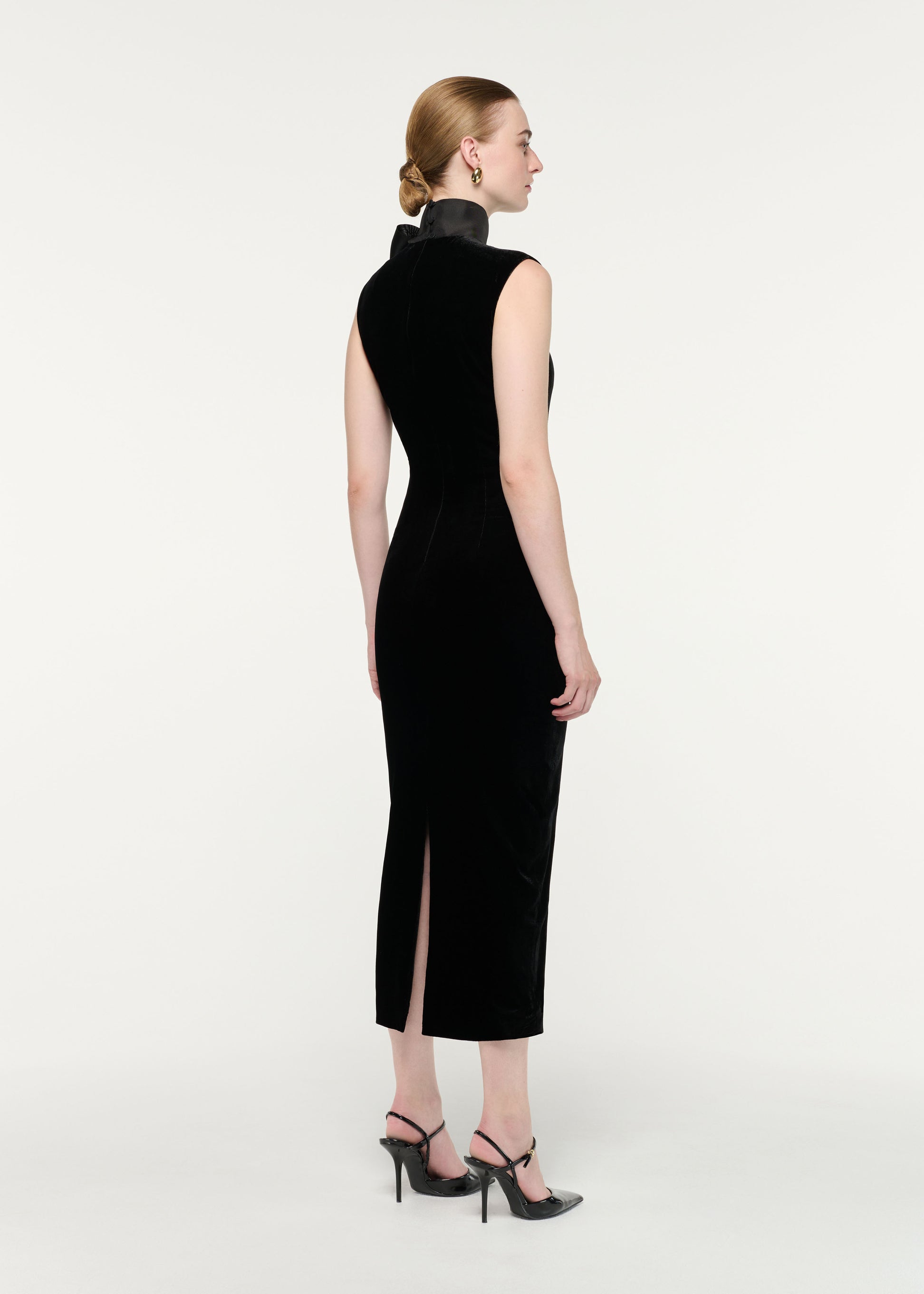 Back view of a model wearing the Velvet Midi Dress With Organza Bow Neck Tie