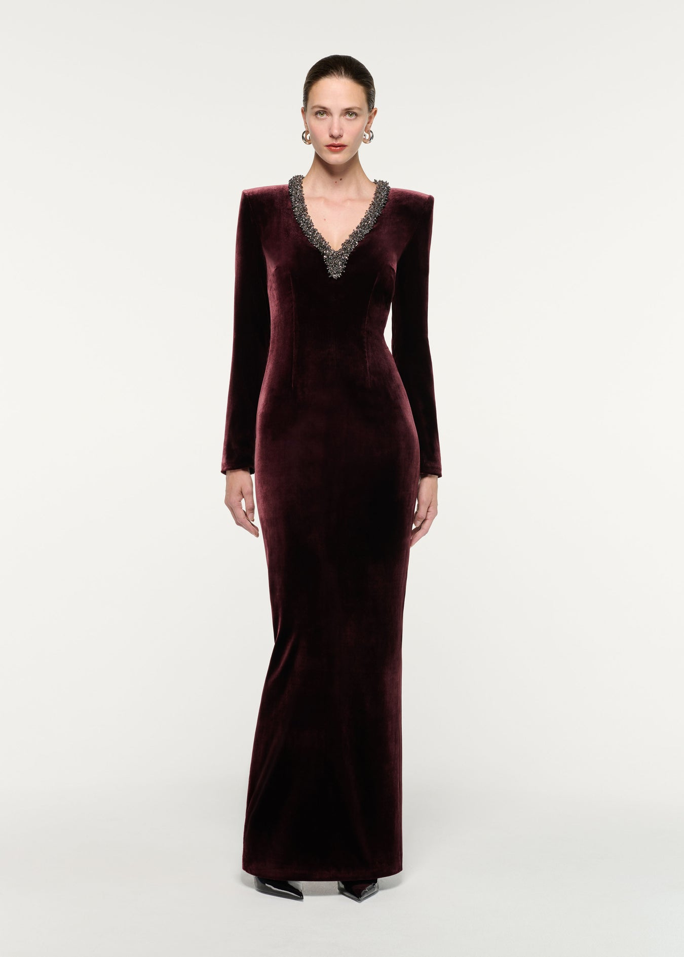 Front view of a model wearing the Long Sleeve Embellished Velvet Gown