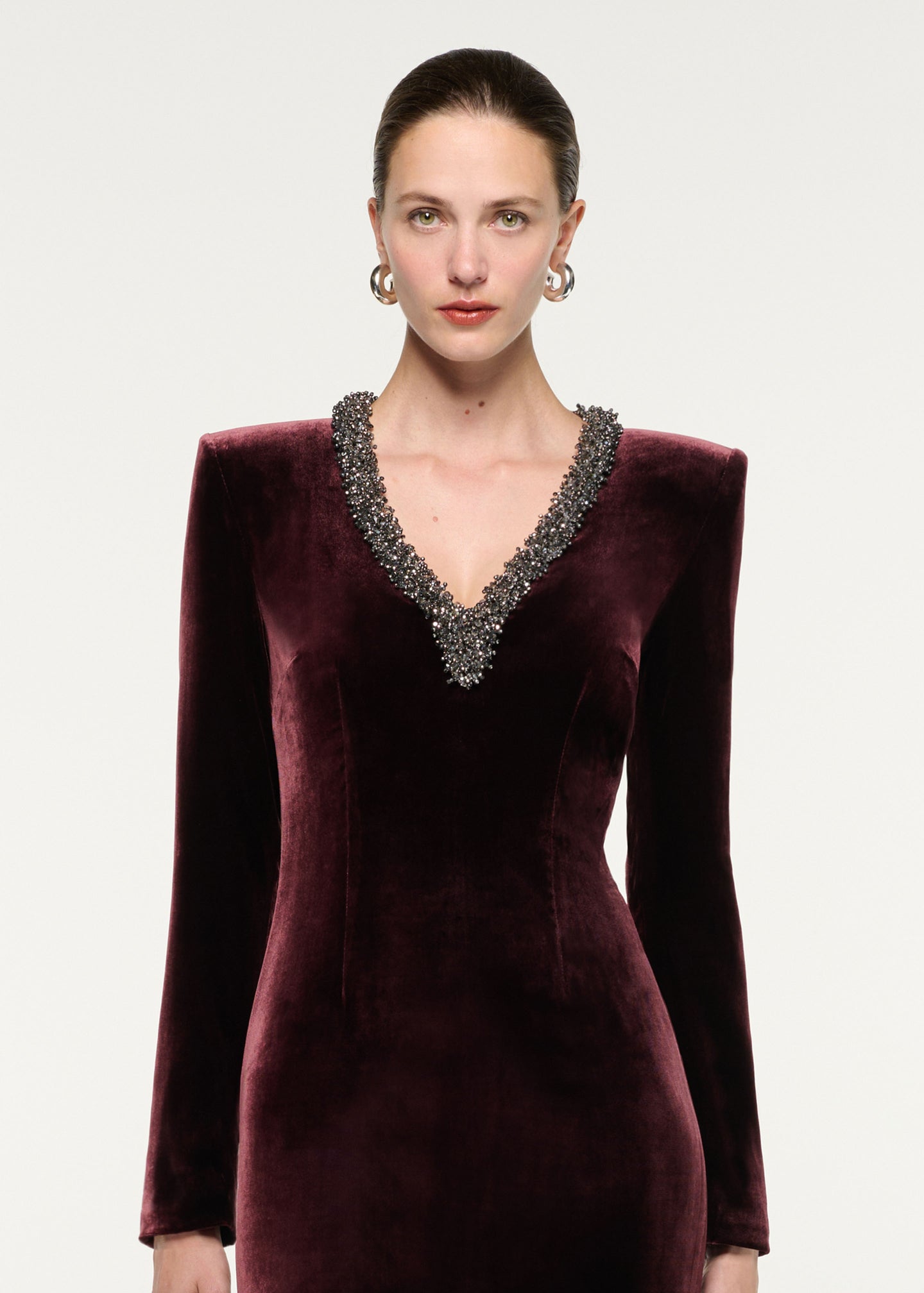 Close up of a model wearing the Long Sleeve Embellished Velvet Gown