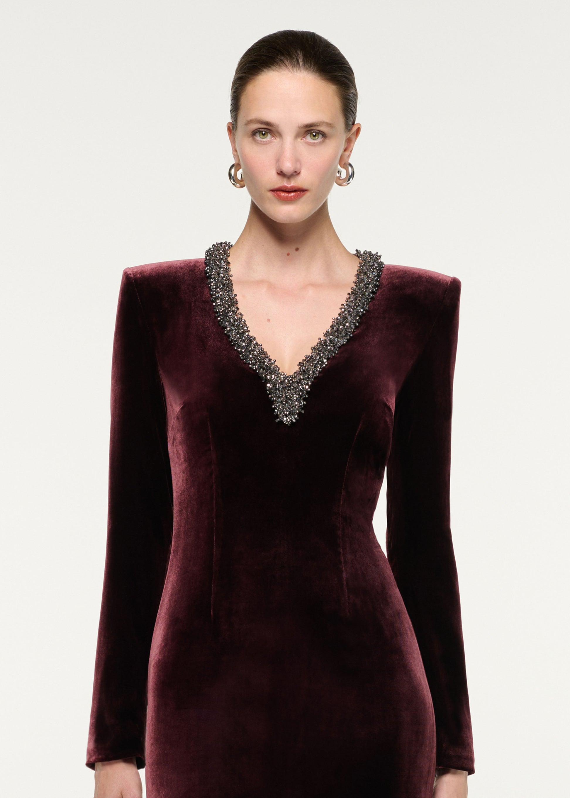 Close up of a model wearing the Long Sleeve Embellished Velvet Gown