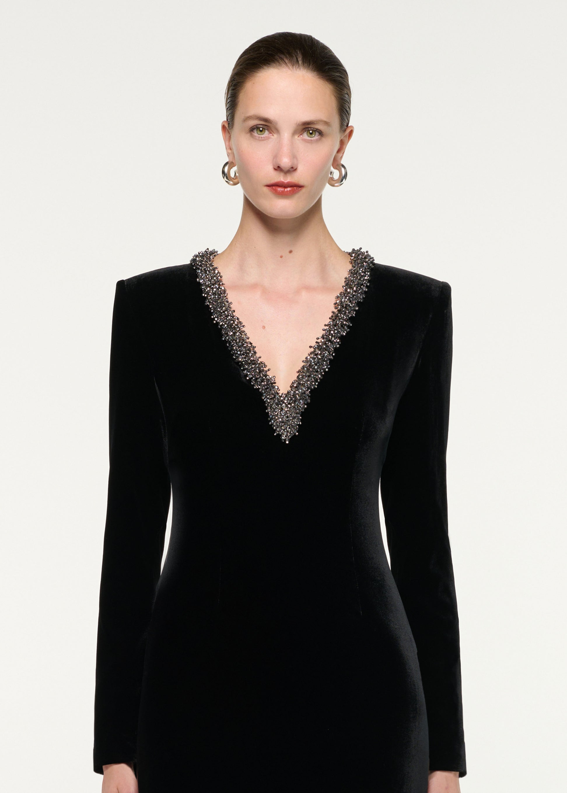 Close up of a model wearing the Long Sleeve Embellished Velvet Mini Dress