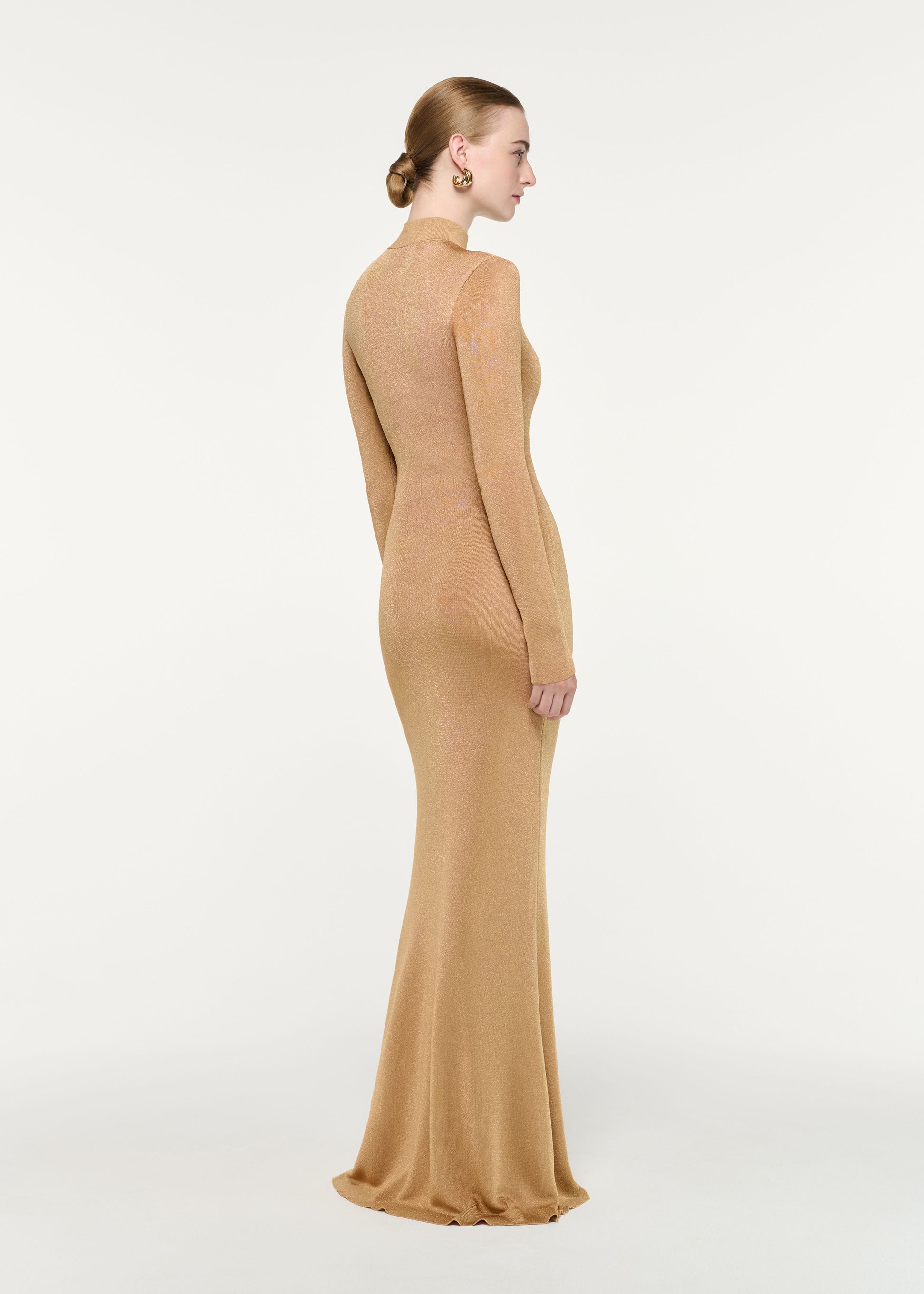 Back view of a model wearing the Lurex Knit Drape Long Sleeve Gown