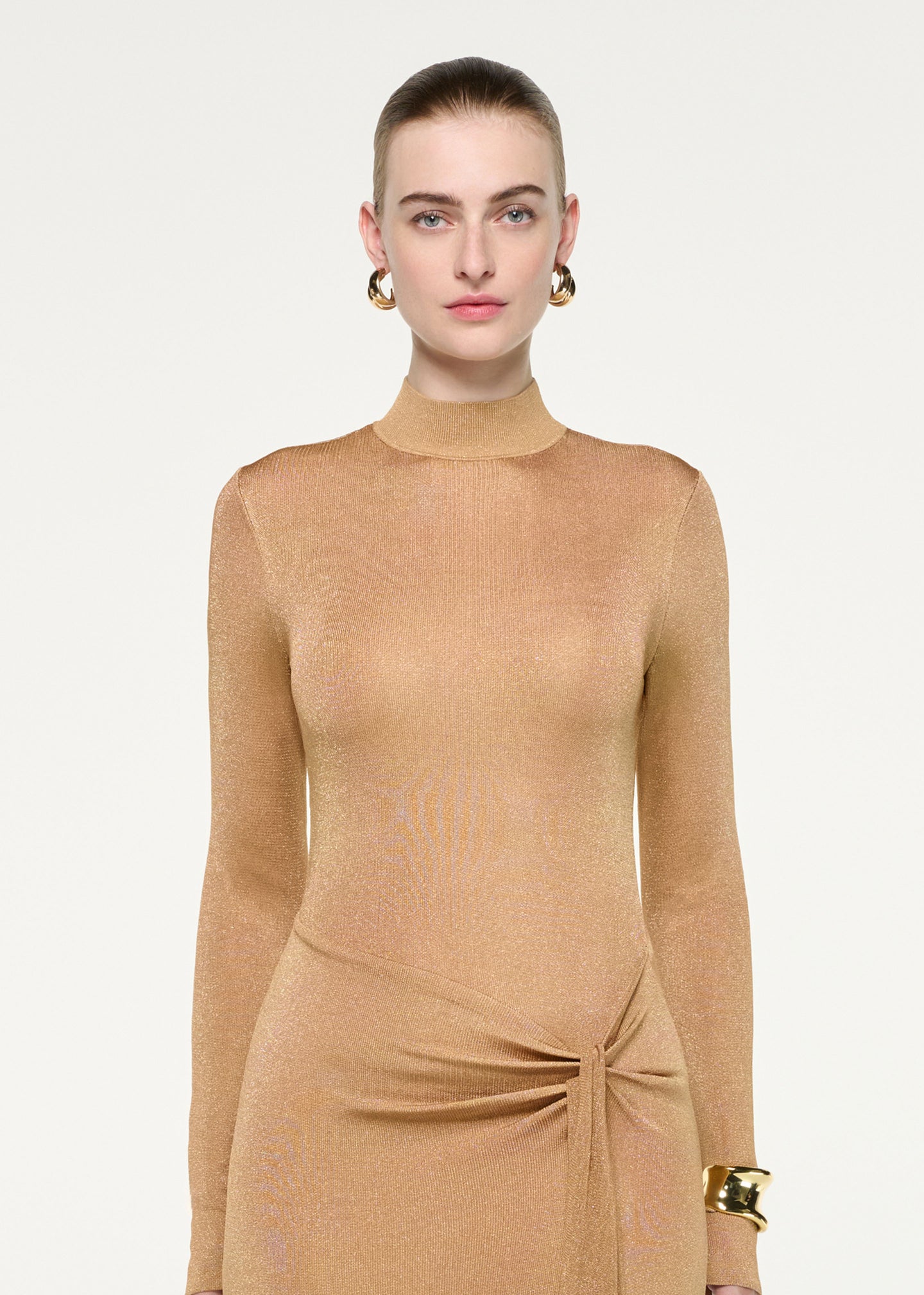 Close up of a model wearing the Lurex Knit Drape Long Sleeve Gown
