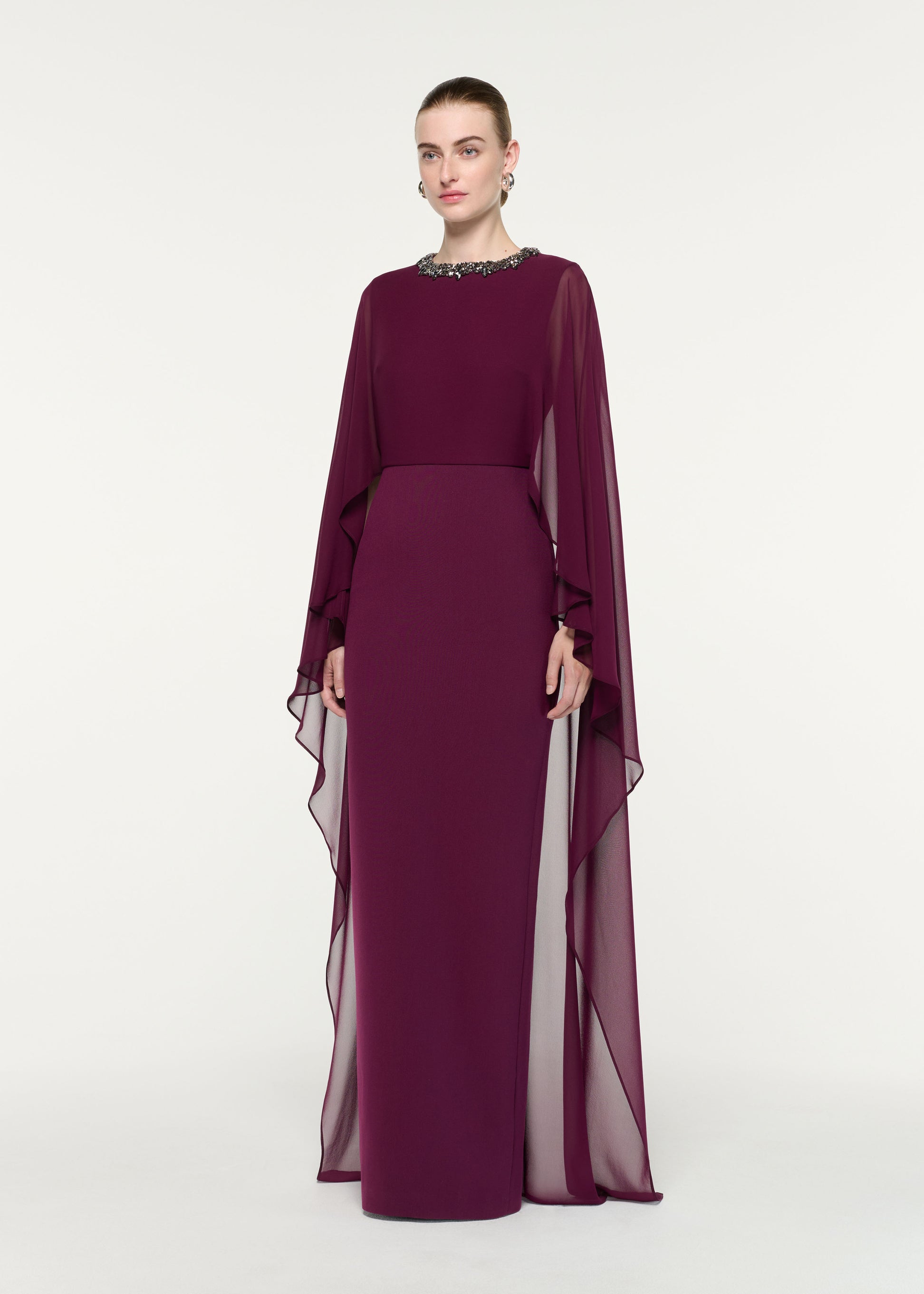 Side view of a model wearing the Embellished Chiffon Cape Gown