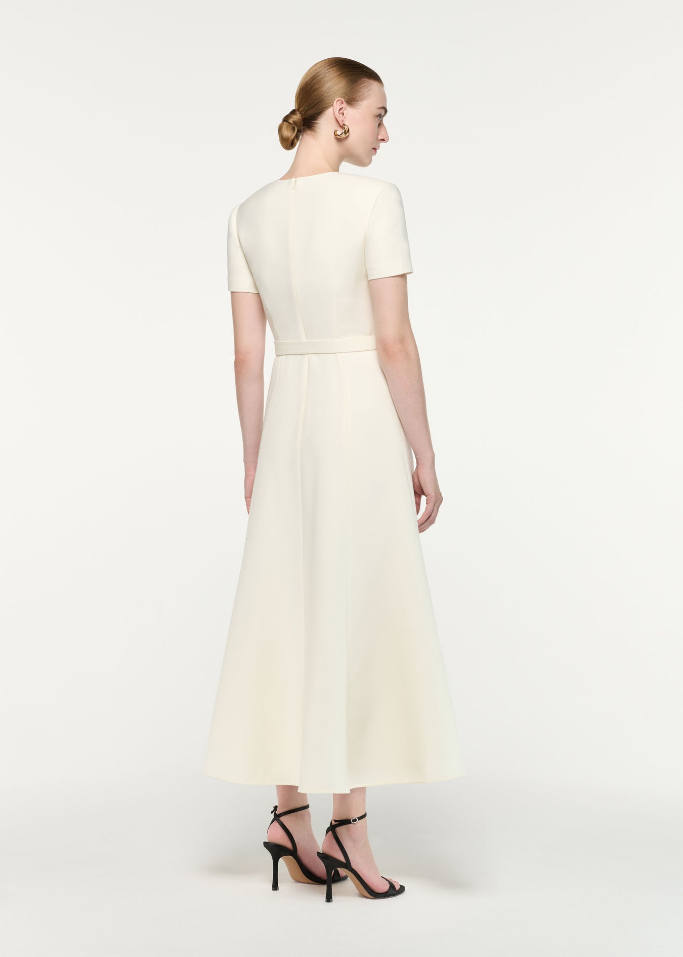 Back view of a model wearing the Gold Button Wool Silk Midi Dress
