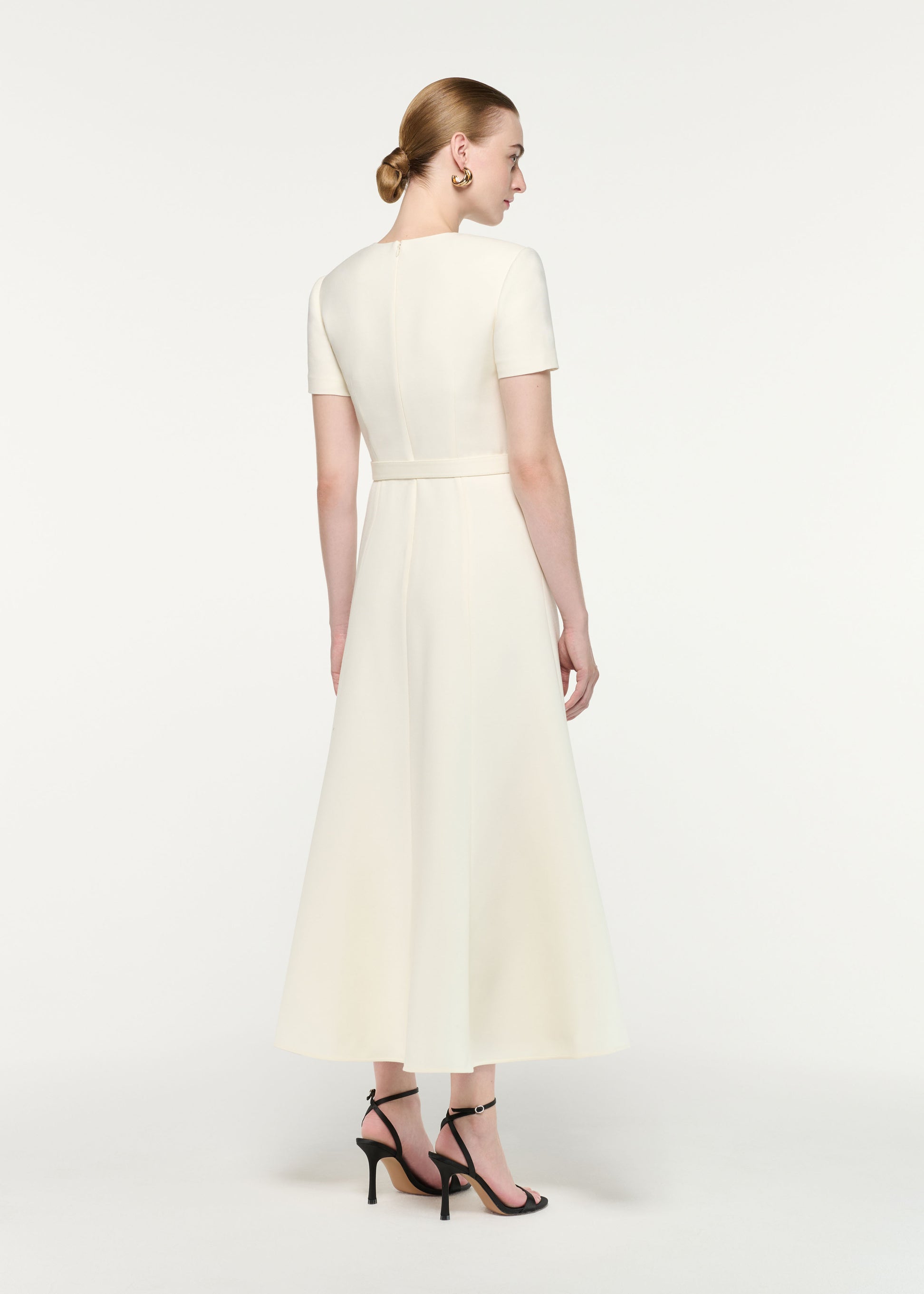 Back view of a model wearing the Gold Button Wool Silk Midi Dress